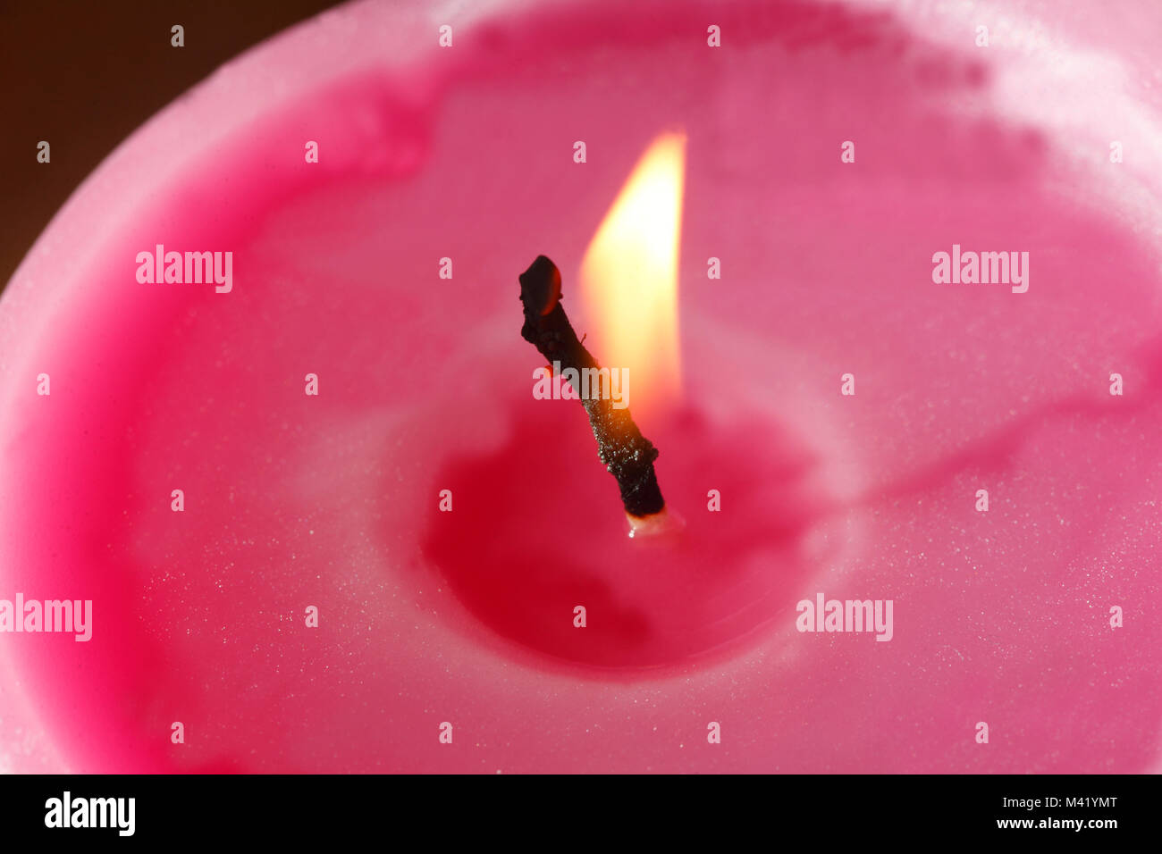pink colored candle with candle Flame Stock Photo Alamy