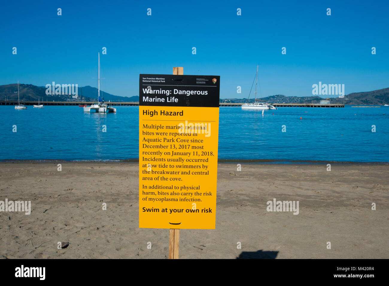 San Francisco, CA - February 03: Warning sign telling swimmers to beware of marine life. This after several swimmers over a 3 week period had been bit Stock Photo