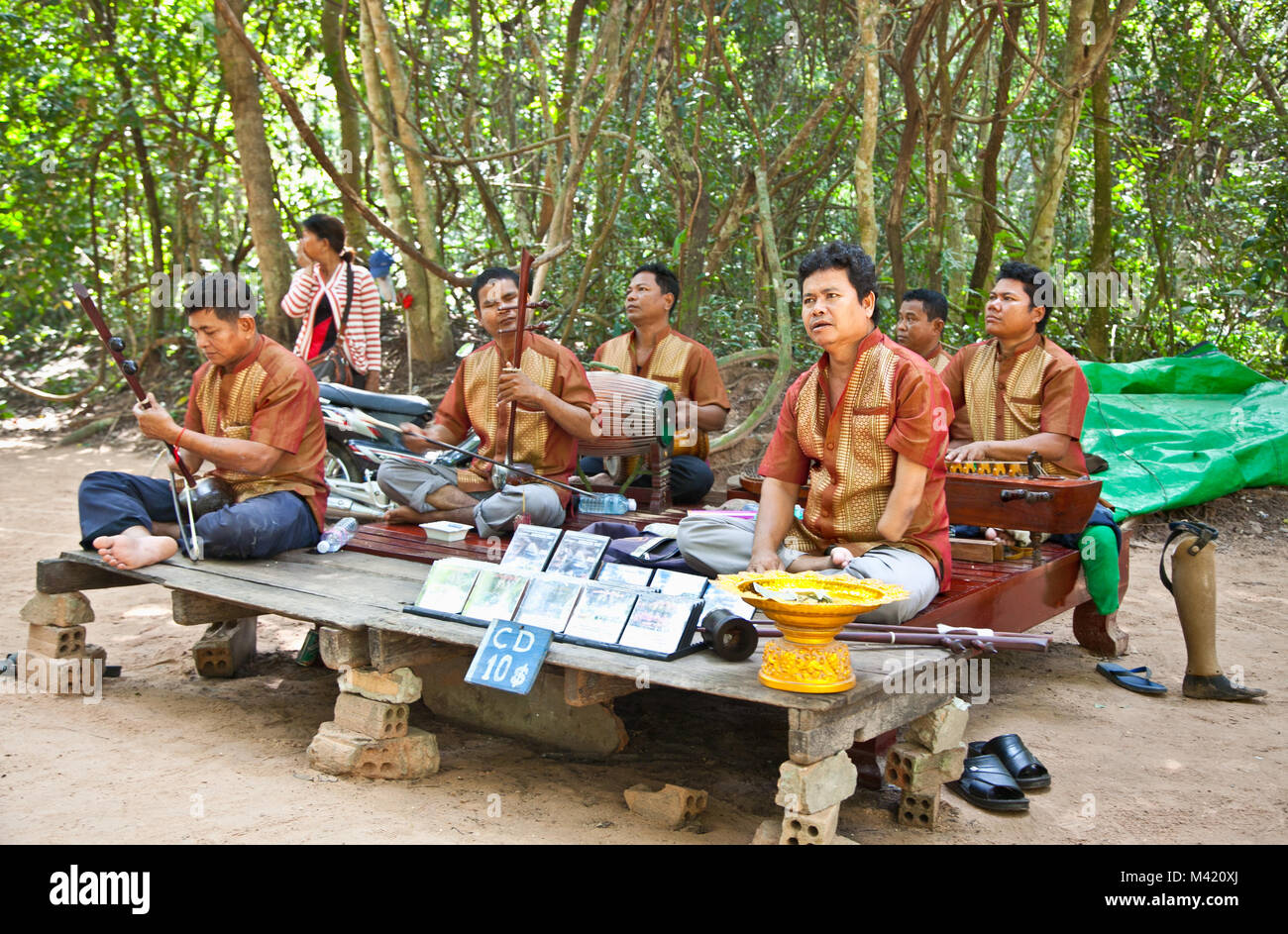 SIEM REAP, CAMBODIA - NOV 20, 2013: Unidentified musicians, victims of anti-personal mines, perform in Angkor Wat and collect money for their associat Stock Photo