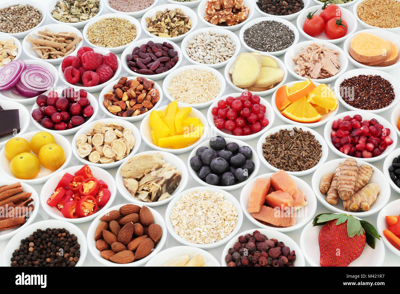 Health food for a healthy heart concept with superfood of fish, fruit, vegetables, pulses, nuts, seeds, grains, cereals with herbs and spices Stock Photo