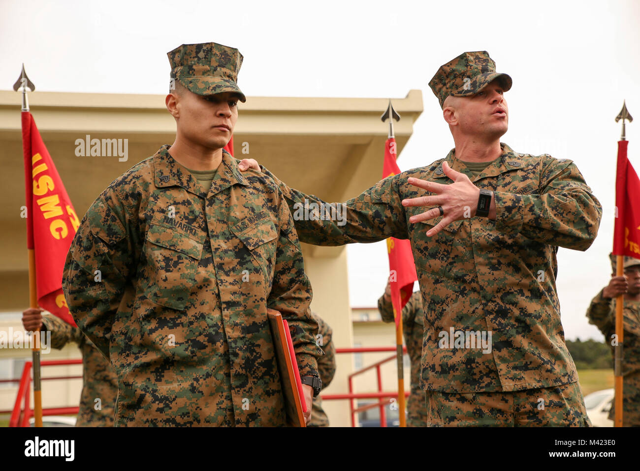 Sgt. Maj. Jeffery Vandentop, right, battalion sergeant major of 3rd Transportation Support Battalion, 3rd Marine Logistics Group, speaks about Sgt. Heriberto Navarro's achievements to the battalion at Camp Foster, Okinawa, Japan, Feb. 8, 2018. Navarro, the supply chief of Headquarters and Service Company, 3rd TSB, 3rd MLG, was honored as III Marine Expeditionary Force’s Noncommissioned Officer of the Year. Navarro won the award for being exemplary in his duties, which included managing roughly $250,000 worth of inventory and equipment during Korean Marine Exchange Program 18.1, as well as his  Stock Photo