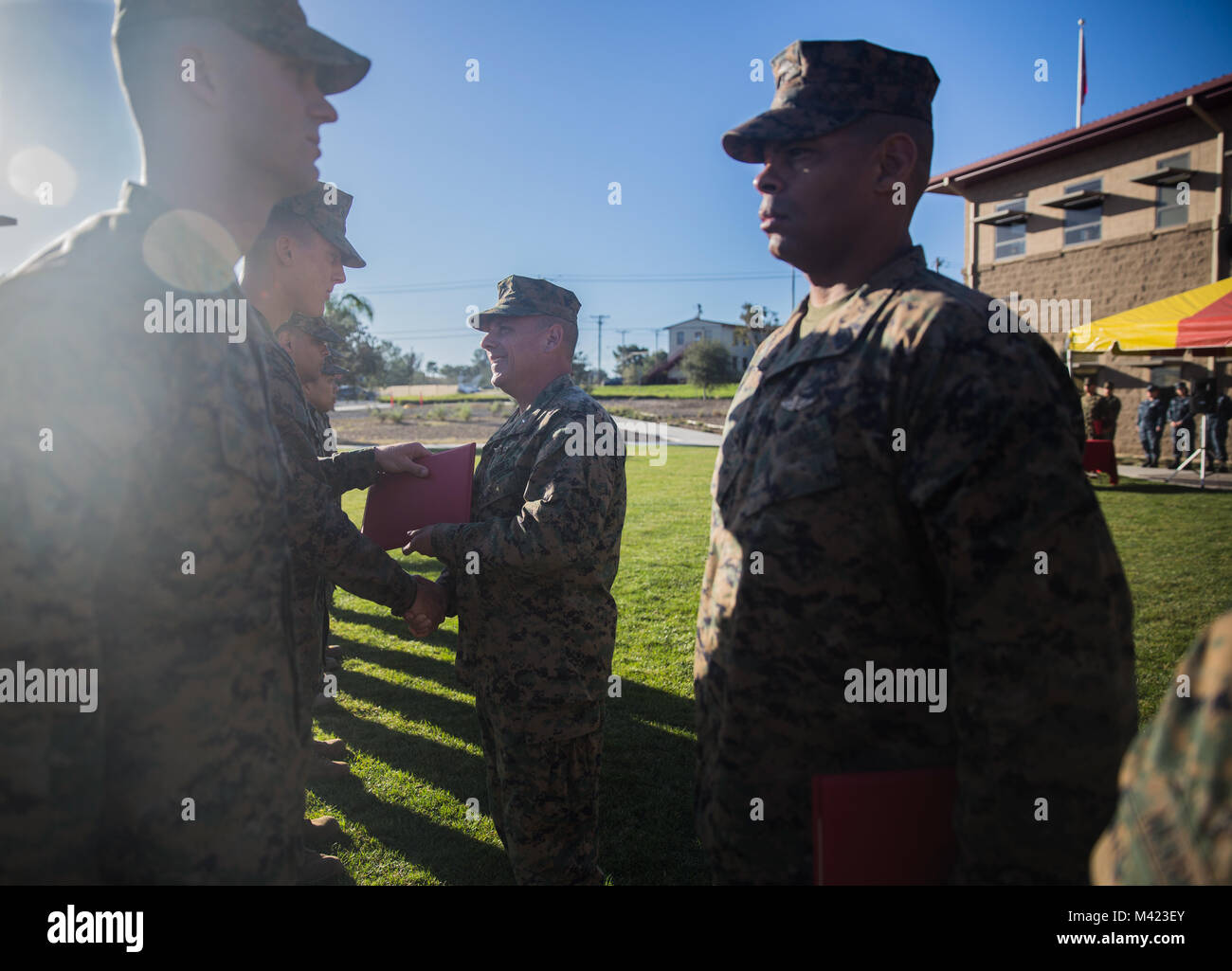 U.S. Marine Cpl. Tyler Foutz, a heavy equipment operator with Combat Logistics Battalion 1, Combat Logistics Regiment 1, 1st Marine Logistics Group, is awarded the Marine of the Year award by Brig. Gen Stephen Sklenka, the commanding general for the 1st MLG, during a quarterly awards ceremony at Camp Pendleton, Calif., Feb. 8, 2018. The awards are given to the Marines and Sailors to recognize the accomplishments achieved by individuals in their respective job fields. (U.S. Marine Corps photo by Cpl. Adam Dublinske) Stock Photo