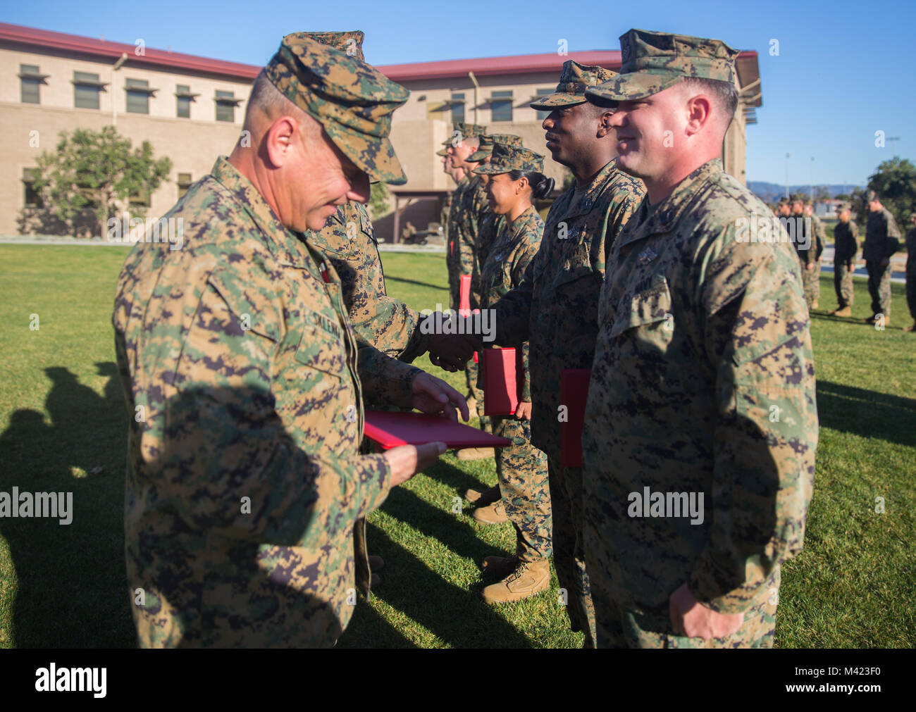 U.S. Navy Petty Officer 1st Class Philip Lopez, a hospital corpsman with 1st Medical Battalion, 1st Marine Logistics Group, is awarded the Senior Sailor of the Quarter award by U.S. Marine Brig. Gen Stephen Sklenka, the commanding general for the 1st MLG, during a quarterly awards ceremony at Camp Pendleton, Calif., Feb. 8, 2018. The awards ceremony is conducted every quarter to highlight the achievements of the Marines and Sailors throughout the unit. (U.S. Marine Corps photo by Cpl. Adam Dublinske) Stock Photo