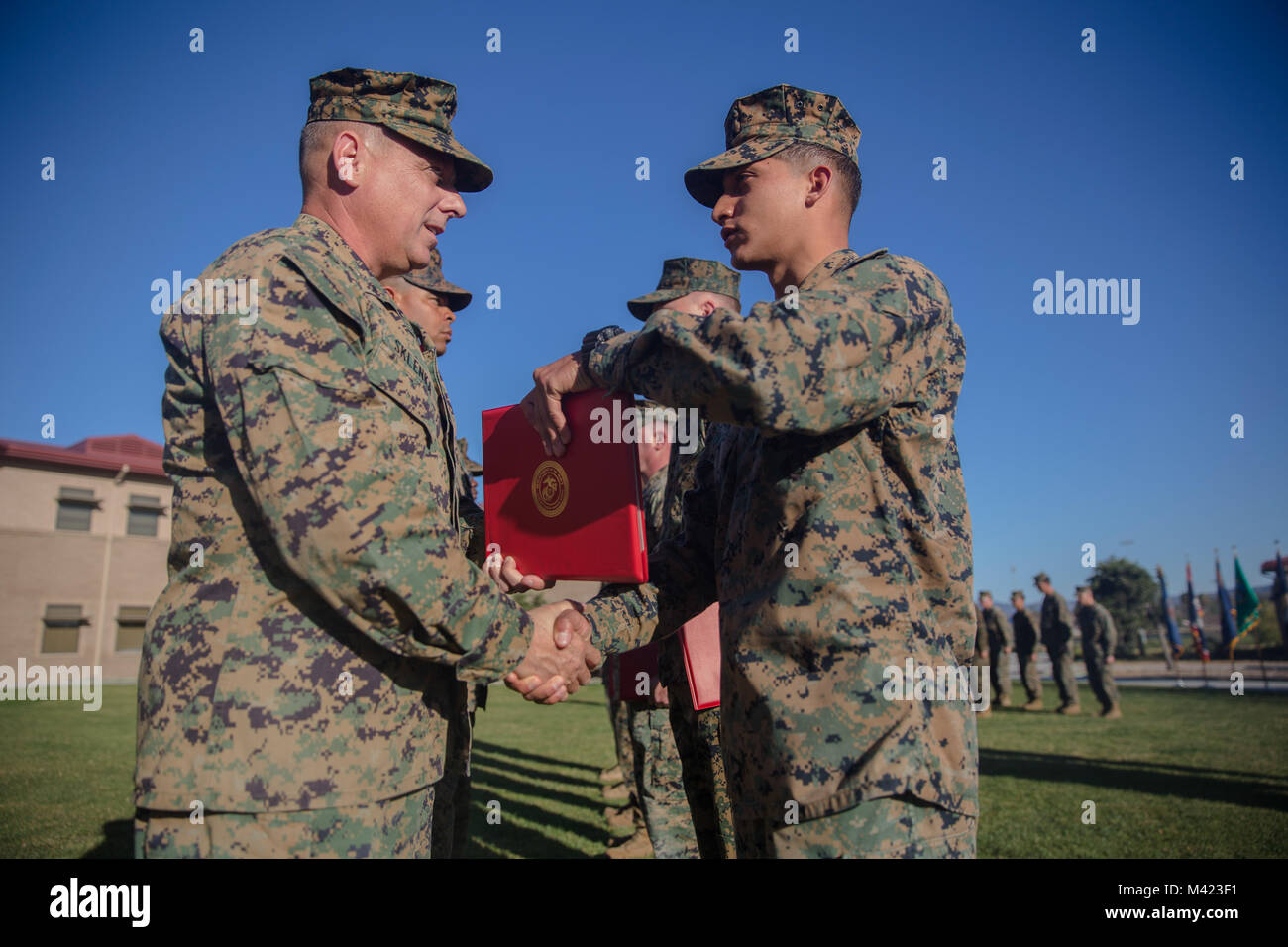 Lance Cpl. Rudy Huerta, a combat engineer with 7th Engineer Support Battalion, 1st Marine Logistics Group, is awarded the Marine of the Quarter award by Brig. Gen Stephen Sklenka, the commanding general for the 1st MLG, during a quarterly awards ceremony at Camp Pendleton, Calif., Feb. 8, 2018. The awards ceremony allows Marines and Sailors of the 1st MLG to be recognized and awarded for their exemplary service and performance in their duties. (U.S. Marine Corps photo by Cpl. Adam Dublinske) Stock Photo