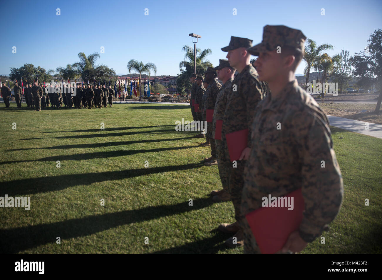 U.S. Marines with 1st Marine Logistics Group stand in formation after being recognized during the quarterly awards ceremony at Camp Pendleton, Calif., Feb. 8, 2018. The awards ceremony is conducted every quarter to highlight the achievements of the Marines and Sailors throughout the unit. (U.S. Marine Corps photo by Cpl. Adam Dublinske) Stock Photo