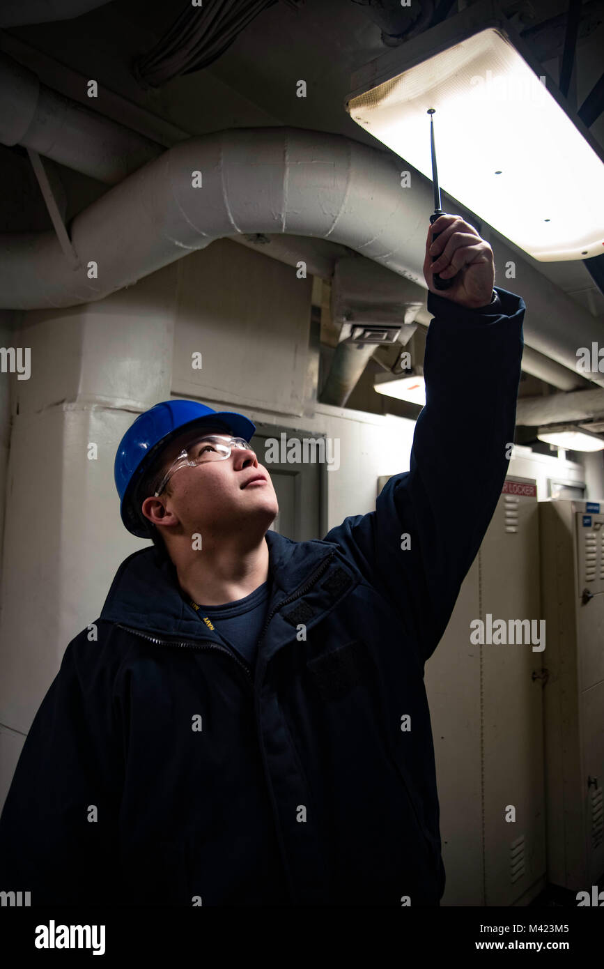 180208-N-IE397-001    PORTSMOUTH, Va. (Feb. 8, 2018) Ship’s Serviceman 3rd Class Daniel Kim, from Chino, Calif., conducts maintenance on a fluorescent lighting fixture in a passageway aboard the aircraft carrier USS Dwight D. Eisenhower (CVN 69) (Ike). Ike is undergoing a Planned Incremental Availability (PIA) at Norfolk Naval Shipyard during the maintenance phase of the Optimized Fleet Response Plan (OFRP). (U.S. Navy photo by Mass Communication Specialist 3rd Class Christopher A. Michaels) Stock Photo