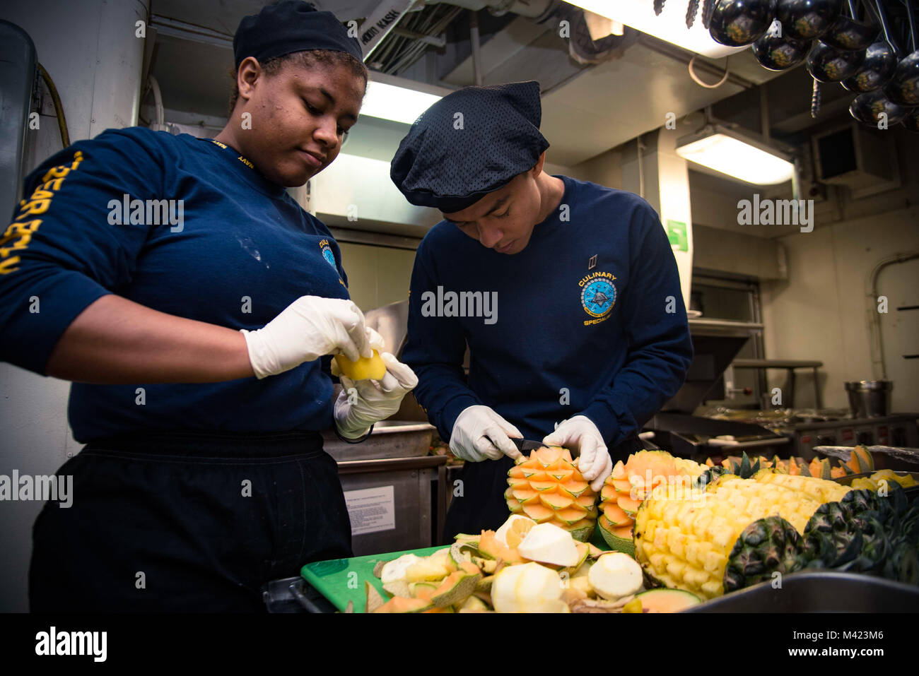 180208-N-IE397-003    PORTSMOUTH (Feb. 8, 2018) Culinary Specialist Seaman Quranna Merritt, from Philadelphia, left, and Culinary Specialist Seaman John Anthony Parocha, from San Francisco, garnish fruit in the wardroom galley aboard the aircraft carrier USS Dwight D. Eisenhower (CVN 69) (Ike). Ike is undergoing a Planned Incremental Availability (PIA) at Norfolk Naval Shipyard during the maintenance phase of the Optimized Fleet Response Plan (OFRP). (U.S. Navy photo by Mass Communication Specialist 3rd Class Christopher A. Michaels) Stock Photo
