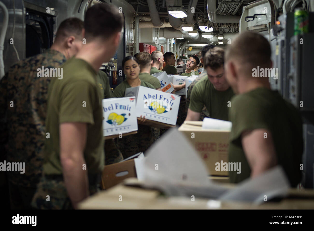 180208-N-WF272-132 SOUTH CHINA SEA (Feb. 8, 2018) Marines, assigned to the 3d Marine Division (MARDIV), move supplies in the wind tunnel of the amphibious assault ship USS Bonhomme Richard (LHD 6) during a replenishment-at-sea. Bonhomme Richard is operating in the Indo-Asia-Pacific region as part of a regularly scheduled patrol and provides a rapid-response capability in the event of a regional contingency or natural disaster. (U.S. Navy photo by Mass Communication Specialist 2nd Class Diana Quinlan/Released) Stock Photo