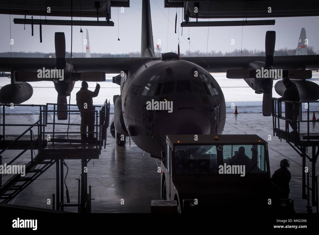 Airmen guide a C-130H Hercules into the hangar to begin an isochronal inspection of the recently acquired aircraft, Feb. 08, 2018, at the 179th Airlift Wing, Mansfield, Ohio. Tail 666 was recently transferred from Yakota Airbase, Japan, and will receive the Mansfield tail markings during the ISO process which is an extensive evaluation of the entire aircraft to ensure proper functionality and mission readiness. (U.S. Air National Guard photo by Tech. Sgt. Joe HarwoodReleased) Stock Photo