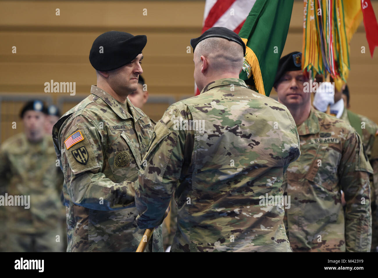 U.S. Army Command Sgt. Maj. Joshua Kreitzer, left, incoming senior enlisted advisor of 709th Military Police (MP) Battalion (BN), 18th MP Brigade, receives the colors from Lt. Col. Jeffrey Searl, commander of 709th MP BN, during a change of responsibility ceremony at Tower Barracks, Grafenwoehr, Germany, Feb. 09, 2018.   (U.S. Army photo by Markus Rauchenberger) Stock Photo