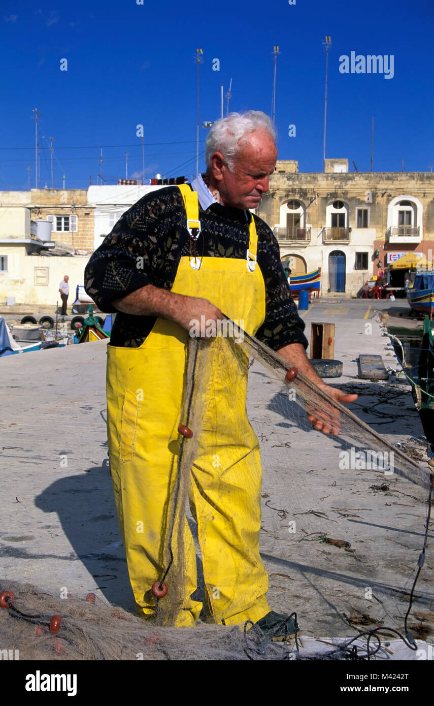 Old fishermen, Marsaxlokk harbour, Malta, Europe Stock Photo