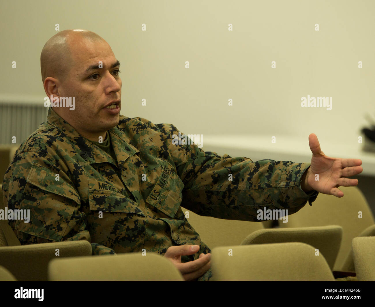 U.S. Marine Corps Staff Sgt. Victor Mexicano, the motor transportation section chief with Marine Wing Support Squadron (MWSS) 171, addresses the Pacific Theater Education Council (PTEC) board at Marine Corps Air Station Iwakuni, Japan, Feb. 9, 2018. PTEC reaches out to Department of Defense schools to help establish a quality education system for service members and their families. (U.S. Marine Corps photo by Lance Cpl. Mason Roy) Stock Photo