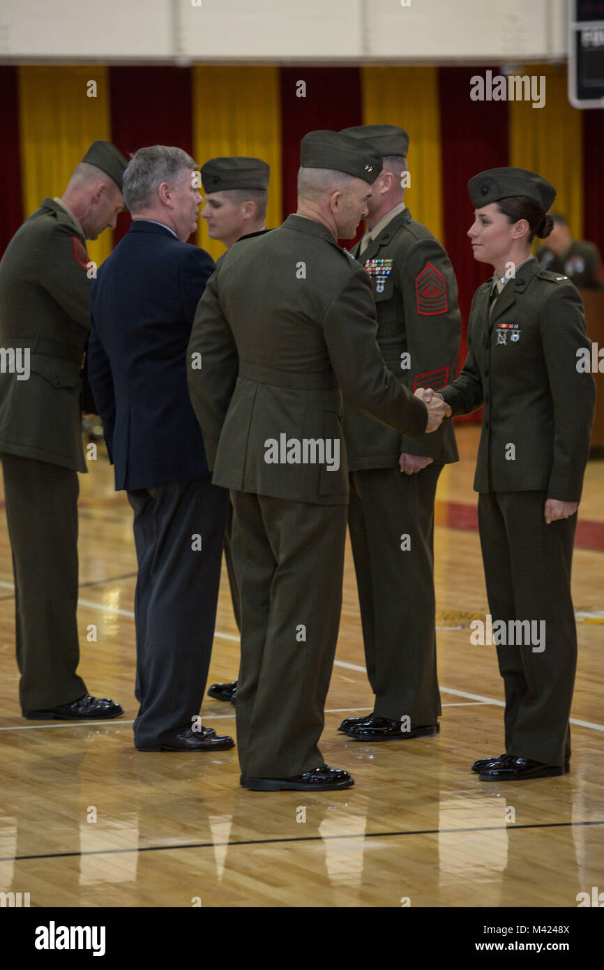 U.S. Marine Corps Maj. Gen. John K. Love, commanding general, 2nd Marine Division (2d MARDIV), left, awards 1st Lt. Lindsay F. Rheiner, 2nd Tank Battalion, 2d MARDIV with the Tarawa award on Camp Lejeune, N.C., Feb. 9, 2018. U.S. Marines, Sailors and civilians participated in the ceremony to reflect on the accomplishments of the Division over the last 77 years. (U.S. Marine Corps photo by Lance Cpl. Taylor N. Cooper) Stock Photo