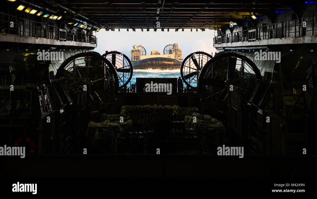 ATLANTIC OCEAN (Feb. 9, 2018) A landing craft, air cushion (LCAC), attached to Assault Craft Unit (ACU) 4, enters the well deck of the amphibious assault ship USS Iwo Jima (LHD 7). The Iwo Jima Amphibious Ready Group embarks the 26th Marine Expeditionary Unit and includes Iwo Jima, the amphibious transport dock ship USS New York (LPD 21), the dock landing ship USS Oak Hill (LSD 51), Fleet Surgical Team 8, Helicopter Sea Combat Squadron 28, Tactical Air Control Squadron 22, components of Naval Beach Group 2 and the embarked staff of Amphibious Squadron 4.  (U.S. Navy photo by Mass Communication Stock Photo