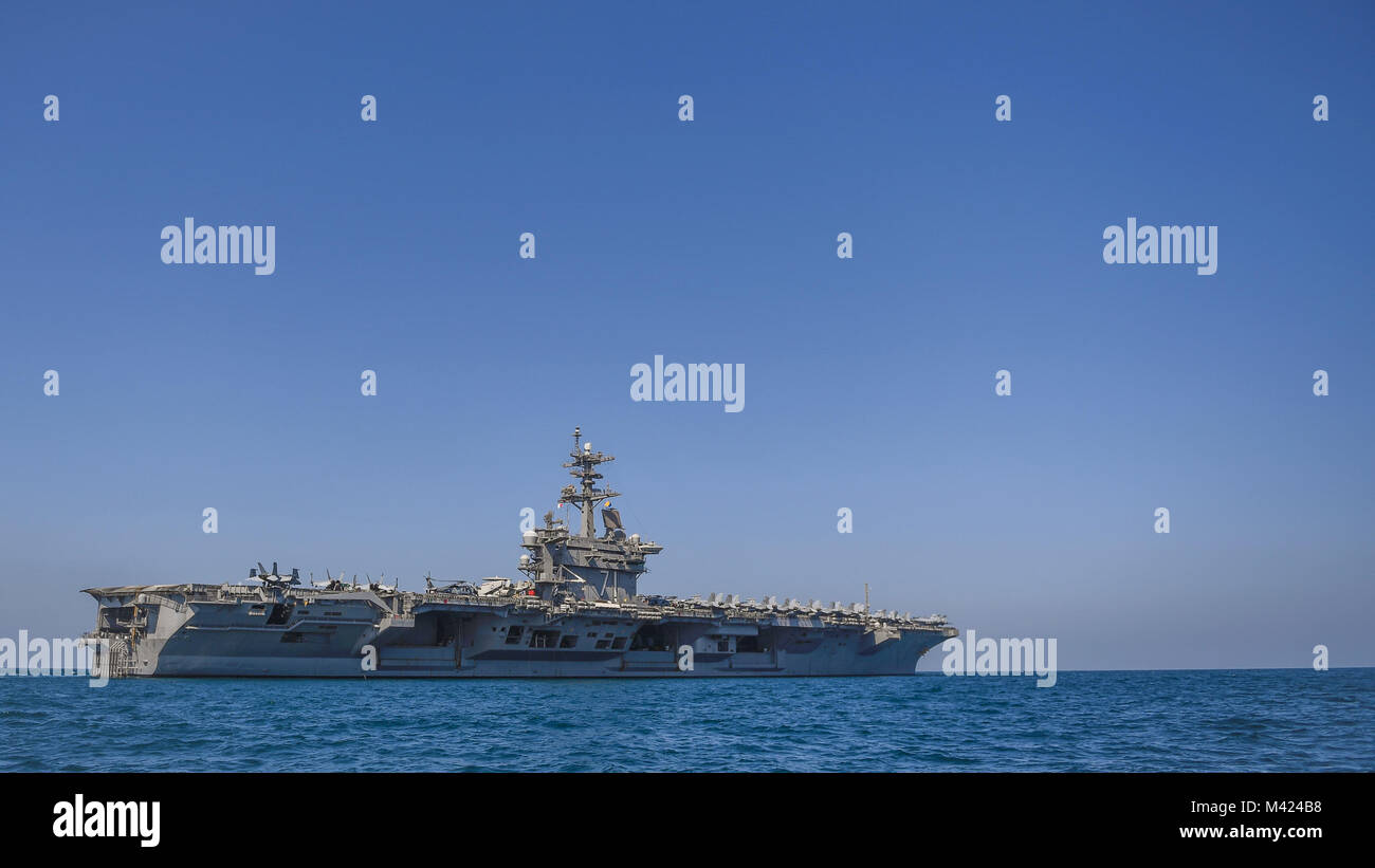 180209-N-MJ135-1097 ARABIAN GULF (Feb. 9, 2018) The aircraft carrier USS Theodore Roosevelt (CVN 71) transits the Arabian Gulf.  Theodore Roosevelt and its carrier strike group are deployed to the U.S. 5th Fleet area of operations in support of maritime security operations to reassure allies and partners and preserve the freedom of navigation and the free flow of commerce in the region. (U.S. Navy photo by Mass Communication Specialist 3rd Class Spencer Roberts/Released) Stock Photo