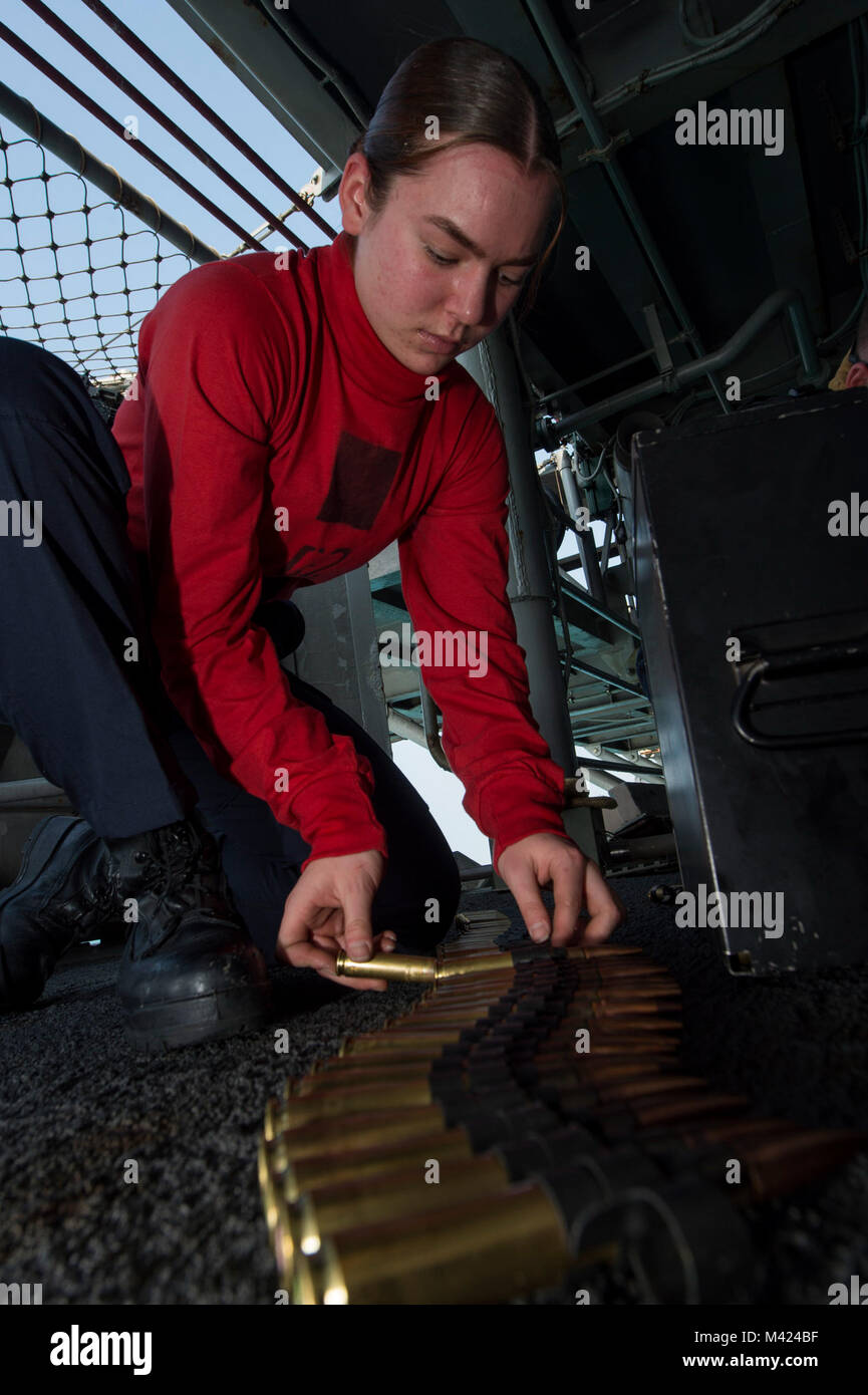 180209-N-NB544-027 GULF OF THAILAND (Feb. 9, 2018) Gunner's Mate Seaman Bianca Yorga, center, from Vista, Calif., connects rounds of .50-caliber machine gun ammunition during small craft action team (SCAT) training aboard the amphibious assault ship USS Bonhomme Richard (LHD 6). Bonhomme Richard is operating in the Indo-Asia-Pacific region as part of a regularly scheduled patrol and provides a rapid-response capability in the event of a regional contingency or natural disaster. (U.S. Navy photo by Mass Communication Specialist 2nd Class Kyle Carlstrom/Released) Stock Photo