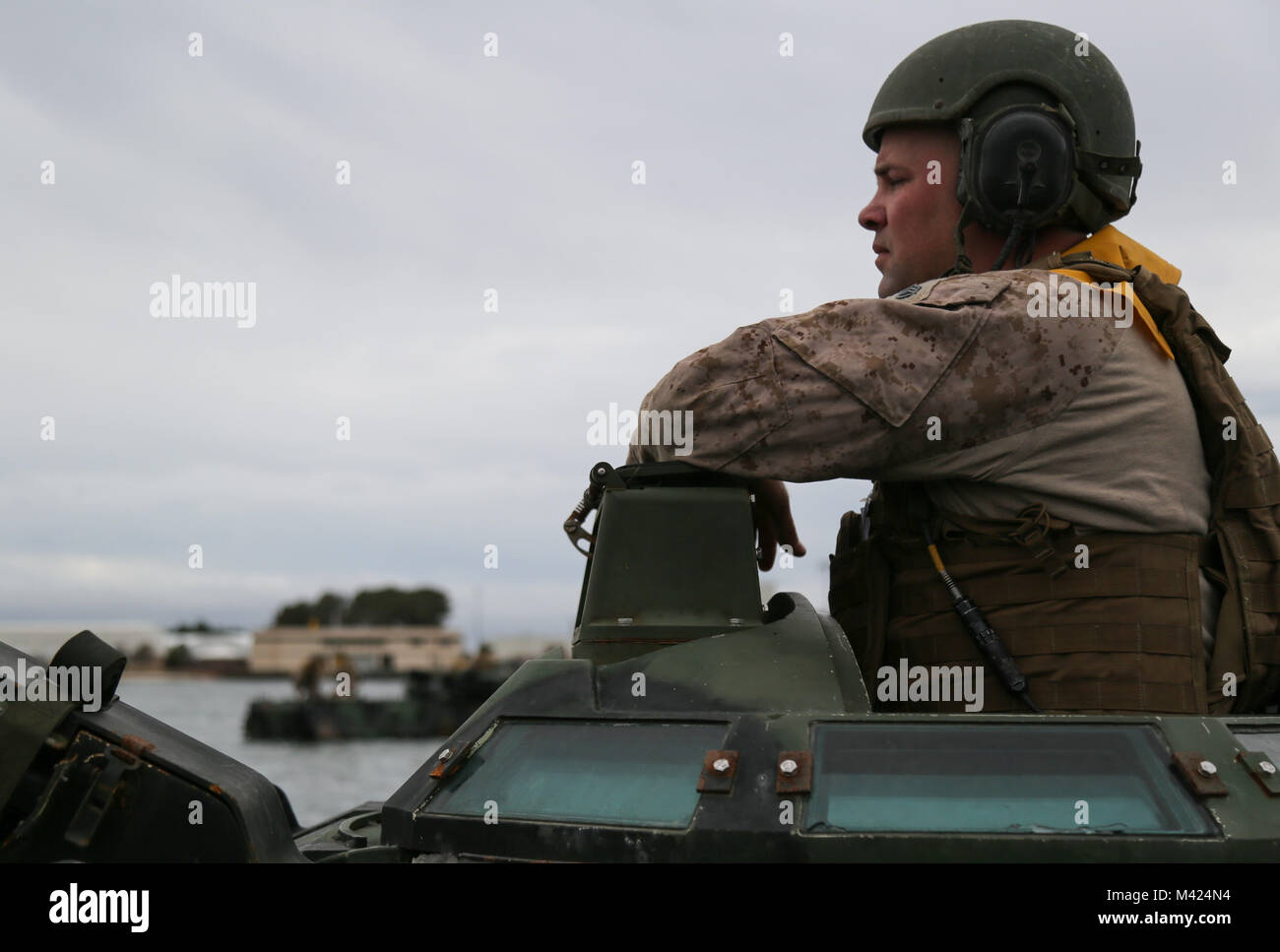 180210-N-IP671-130 NORFOLK, Va., (Feb. 10, 2018) -- Staff Sgt. Daniel Porter observes a training exercise from the top of an Amphibious Assault Vehicle at Joint Expeditionary Base Little Creek.  This exercise is held every six months to keep the Marines ready for water recovery scenarios. The 4th Marine Division provides combat support personnel to augment the active duty component in time or war or during a national emergency.  (U.S. Navy photo by Mass Communication Specialist 1st Class Jennifer Wilson/Released) Stock Photo