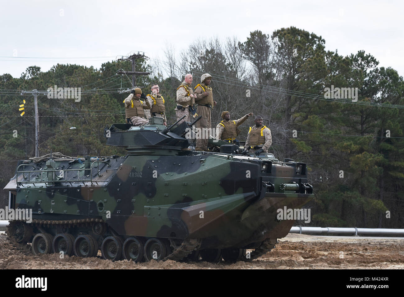 180210-N-FF140-002 NORFOLK, Va., (Feb. 10, 2018) -- Marines assigned to 4th Marine Division, 1st Platoon, observe a simulated recovery mission while standing on an amphibious assault vehicle during a training exercise at Joint Expeditionary Base Little Creek. The semi-annual exercise supports the division's mission to provide trained combat support personnel to augment the active component in time of war or national emergency. (U.S. Navy photo by Mass Communication Specialist 2nd Class Jacob D. Galito/Released) Stock Photo