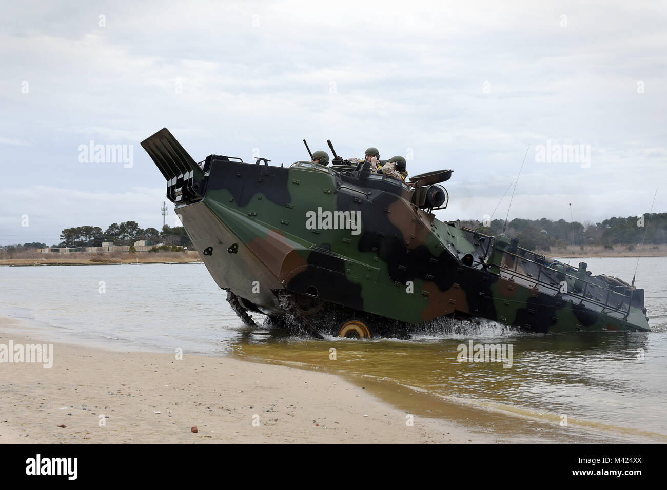 180210-N-FF140-003 NORFOLK, Va., (Feb. 10, 2018) -- Marines assigned to 4th Marine Division, 2nd Platoon, perform an attack-the-beach maneuver in an amphibious assault vehicle during a training exercise at Joint Expeditionary Base Little Creek. The semi-annual exercise supports the division's mission to provide trained combat support personnel to augment the active component in time of war or national emergency. (U.S. Navy photo by Mass Communication Specialist 2nd Class Jacob D. Galito/Released) Stock Photo