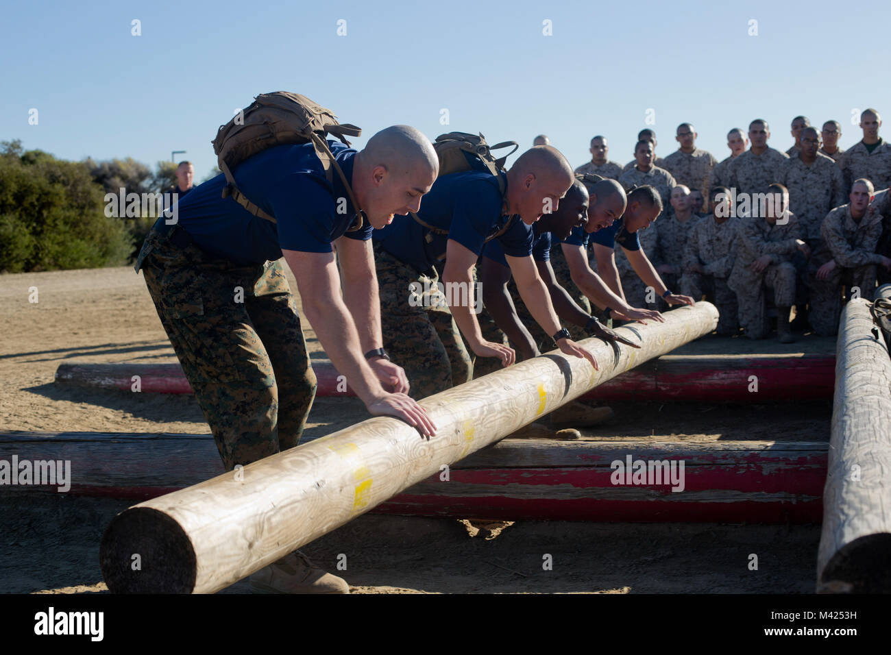 Drill instructors with Kilo Company, 3rd Recruit Training Battalion, demonstrate a physical training event at Marine Corps Recruit Depot San Diego, Jan. 22. Before allowing the recruits to begin the event, drill instructors demonstrated the proper techniques needed to successfully endure it. Annually, more than 17,000 males recruited from the Western Recruiting Region are trained at MCRD San Diego. Kilo Company is scheduled to graduate March 16. Stock Photo