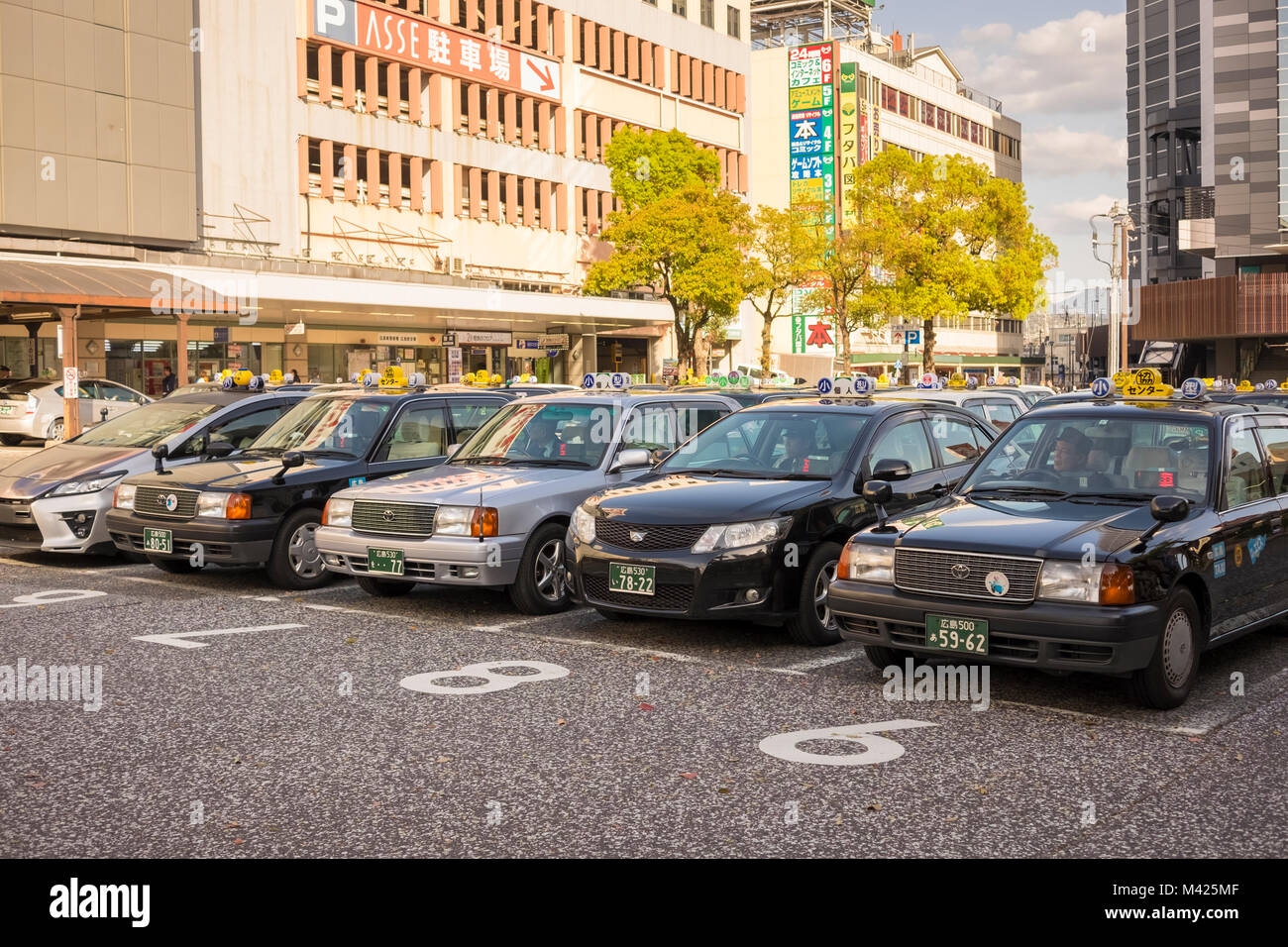 Taxis and a taxi rank in Hiroshima, Japan Stock Photo