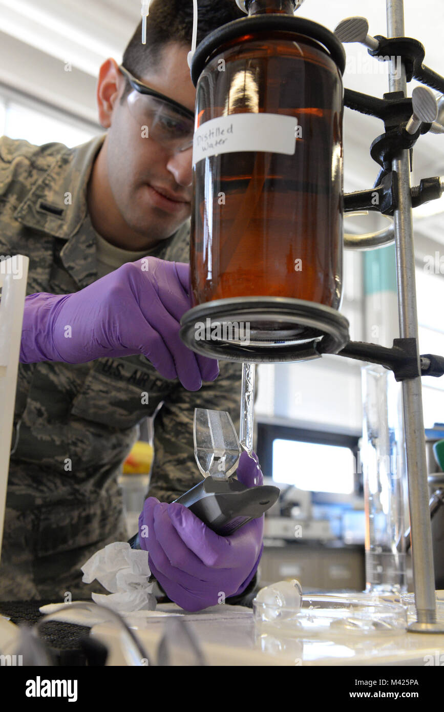 U.S. Air Force 1st Lt. William Gomez, Aerospace Fuels Laboratory deputy chief, places a sample extracted from jet fuel onto an anti-icing additive test kit in the Quality Surveillance Fuels Lab at Wright-Patterson Air Force Base, Ohio, Jan. 25, 2018. The Air Force Petroleum Agency operates six laboratories worldwide with the largest located at Wright-Patt. (U.S. Air Force photo by Michelle Gigante) Stock Photo