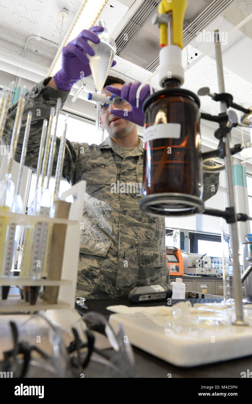 U.S. Air Force 1st Lt. William Gomez, Aerospace Fuels Laboratory deputy chief, checks for separation of fuel and water in a sample at the Quality Surveillance Fuels Lab, Wright-Patterson Air Force Base, Ohio, Jan. 25, 2018. The additive being tested for prevents water in the fuel from freezing as it separates in flight.  (U.S. Air Force photo by Michelle Gigante) Stock Photo
