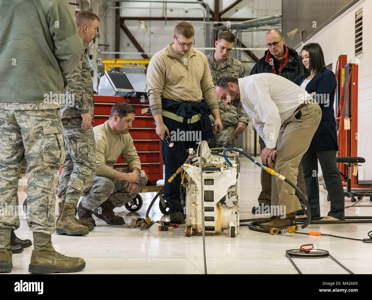 Justin Smoak, Samson Rope application engineering manager, Ferndale, Wash., observes how the synthetic winch line feeds into a C-17 Globemaster III winch assembly, Jan. 30, 2018 at Dover Air Force Base, Del. Smoak watched maintainers attach and wind the cable onto the winch while looking for any potential issues. (U.S. Air Force photo by Roland Balik) Stock Photo