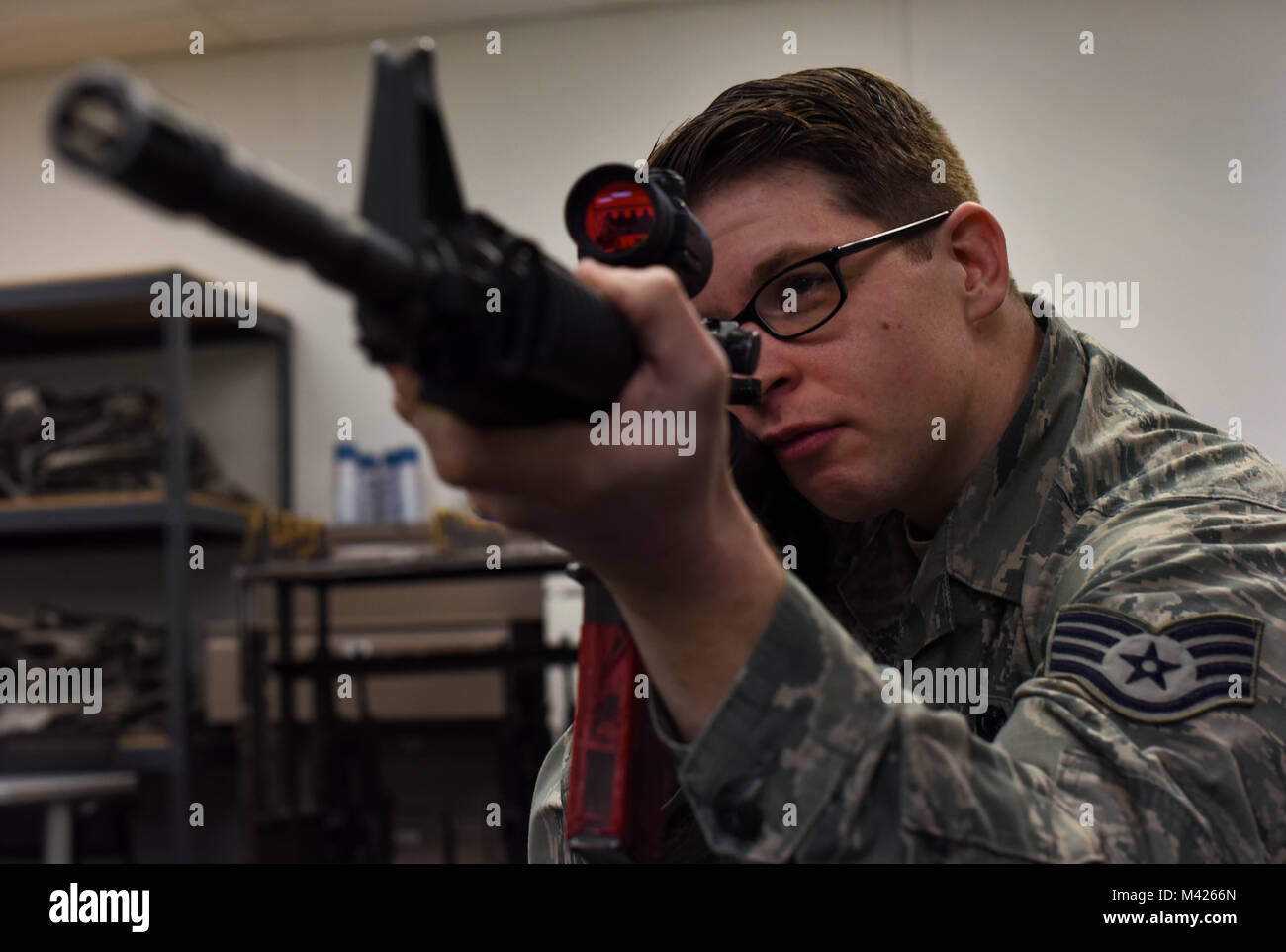 Staff Sgt. John A. Lucic, 62nd Maintenance Squadron unit training manager, looks through the scope of an M-4 carbine during the 627th Security Forces Squadron’s Combat Arms Training and Maintenance class at Joint Base Lewis-McChord, Wash., Jan. 31, 2018. The course consisted of a classroom portion followed by shooting at a range to qualify. (U.S. Air Force photo by Senior Airman Tryphena Mayhugh) Stock Photo