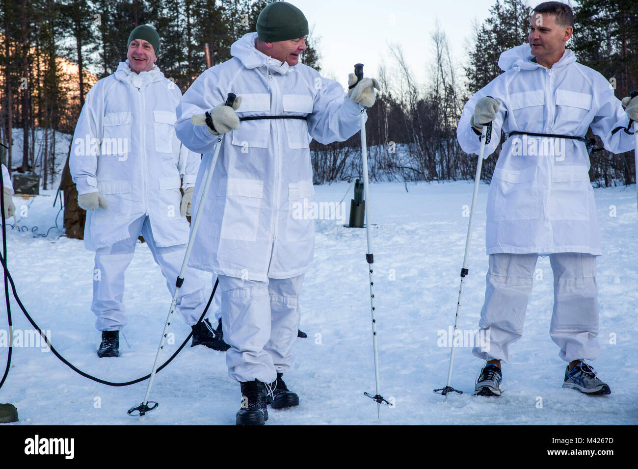 Norwegian Maj.Gen. Odin Johannessen, the chief of Norwegian Army, participates in an ice-breaking drill alongside Maj.Gen. Russell A.C. Sanborn, the commander of Marine Corps Forces Europe and Africa, in Bardufoss, Norway, Jan. 31, 2018. Sanborn participated in this training evolution to experience the training the Marines have endured throughout their time in Norway. The drill is a cornerstone of advanced cold-weather training, intended to teach a service member the immediate steps to take when falling in ice. (U.S. Marine Corps photo by Cpl. Careaf L. Henson/Released) Stock Photo