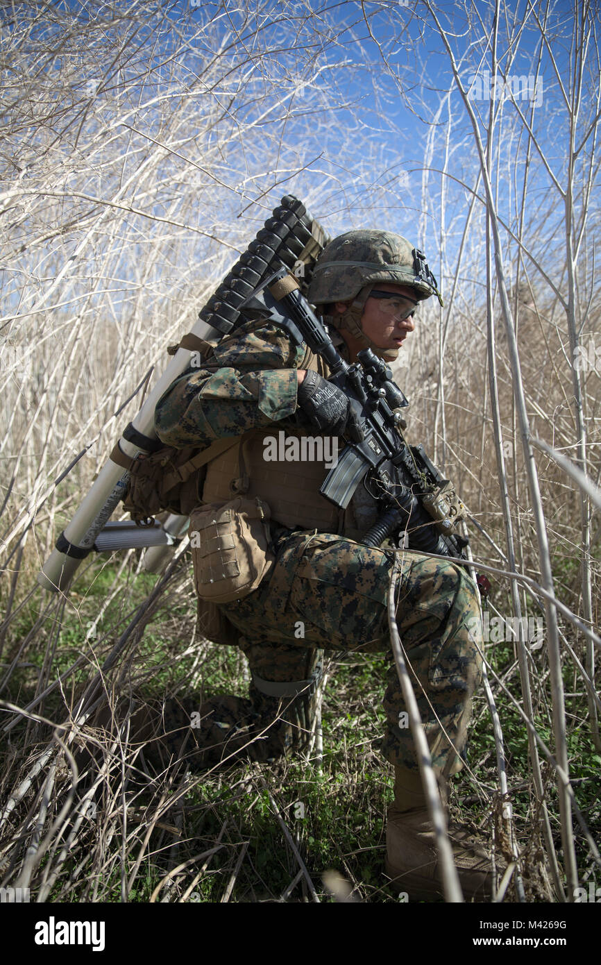 U.S. Marine Corps Lance Cpl. Brian Sanchezangel, rifleman, Kilo Company, Battalion Landing Team (BLT), 3rd Battalion, 1st Marine Regiment awaits the order to push forward during an assault exercise on Camp Pendleton, California, Jan. 31, 2018. In addition to refining command and control procedures, BLT 3/1 validated their ability to conduct raids from air and mechanized platforms. (U.S. Marine Corps photo by Cpl. Danny Gonzalez) Stock Photo