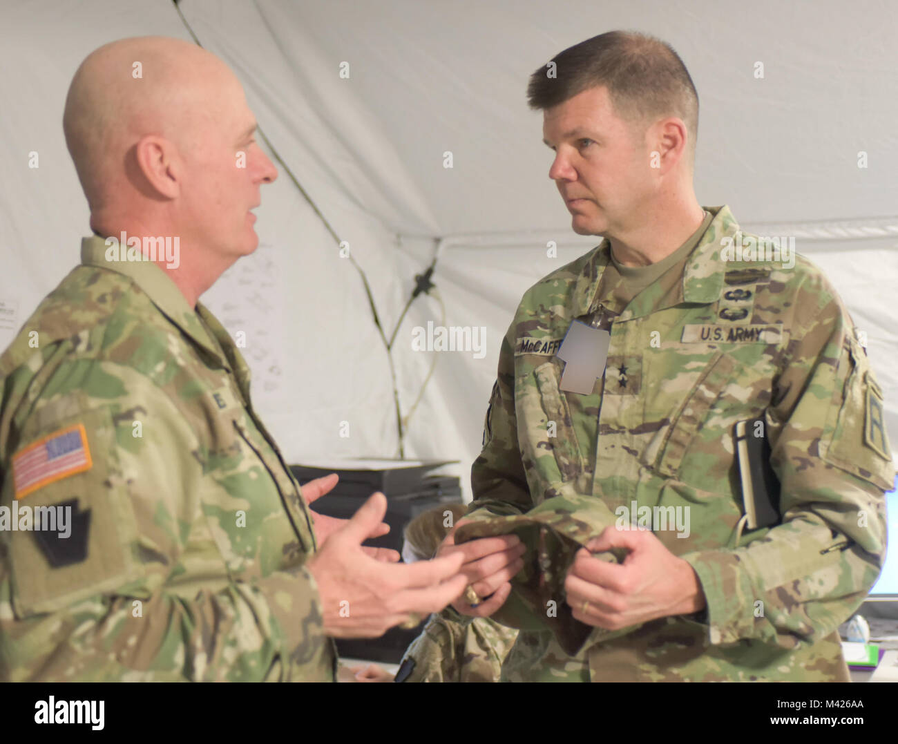 Maj. Gen. Todd McCaffrey (right), First Army Division East commanding general, talks with Command Sgt. Maj. John Jones, command sergeant major of the Pennsylvania Army National Guard's 28th Infantry Division, during the 28th ID's culminating training exercise at Fort Hood, Texas, Jan. 31, 2018. About 500 Soldiers in the Pennsylvania unit's headquarters are preparing to deploy to the Middle East. “(First Army personnel) have been very helpful assisting us on our way to deployment and with the validation process,” Jones said. (Photo altered for security purposes.) Stock Photo