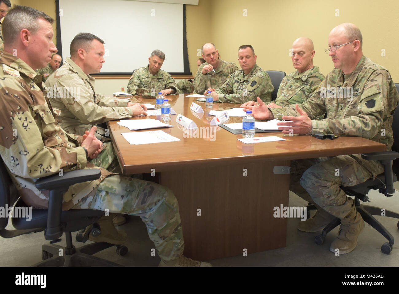 Maj. Gen. Andrew Schafer Jr. (right) and Command Sgt. Maj. John Jones (second from right), command team of the Pennsylvania Army National Guard's 28th Infantry Division, participate in a simulated key leader engagement with role-played Kuwait military leaders during the 28th ID's culminating training exercise with First Army at Fort Hood, Texas, Jan. 31, 2018. About 500 28th ID Soldiers will be headquartered in Kuwait during their upcoming nine-month deployment. Stock Photo