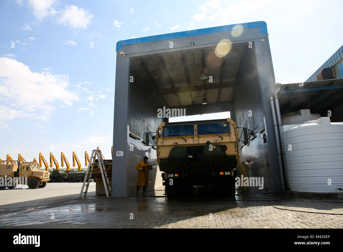 JEBEL ALI PORT, United Arab Emirates (Jan. 30, 2018) Emirati contractors wash down U.S. military vehicles before loading the equipment and gear onto USNS Seay (T-AKR 302) during exercise Native Fury 18. The exercise is designed to train Special Purpose Marine Air-Ground Task Force-Native Fury Marines and U.S. Navy Sailors in maritime prepositioning force operations and aims to increase proficiency, expand levels of cooperation, enhance maritime capabilities, and promote long-term regional stability and interoperability between the United Arab Emirates and the U.S. (U.S. Marine Corps photo by S Stock Photo