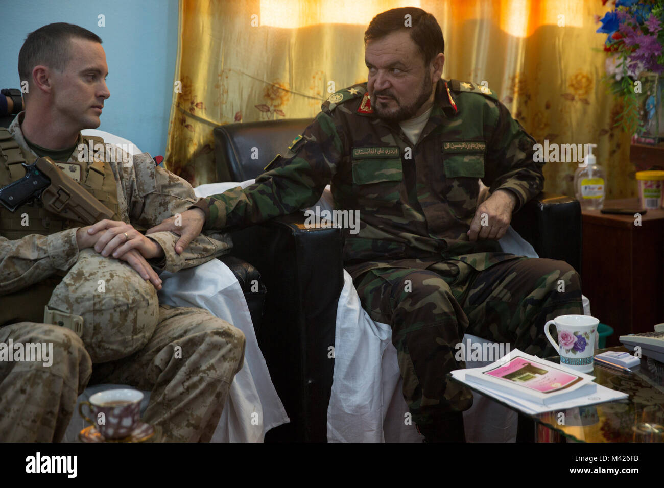 Brig. Gen. Hussain Gul, Shorab Regional Hospital commander, with the Afghan National Army (ANA) 215th Corps talks with his  of Task Force Southwest counterpart at Shorab Regional Hospital, at Camp Shorabak, Afghanistan, Feb. 1, 2018. Gul and his counterpart met to discuss sustainment and improvement of medical facilities to better care for ANA soldiers. (U.S. Marine Corps photo by Staff Sgt. Melissa Karnath/Released) Stock Photo