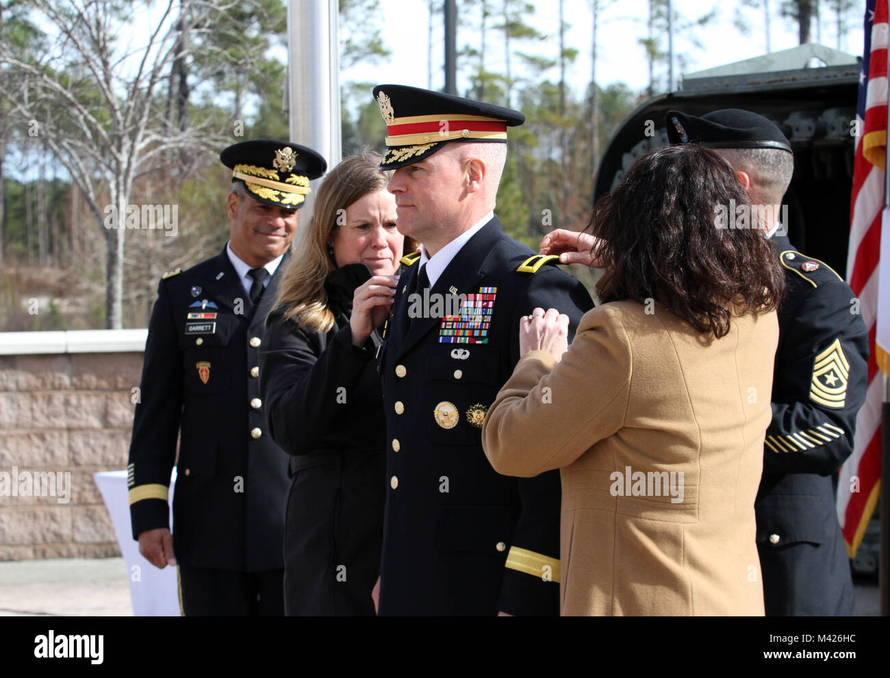 SHAW AIR FORCE BASE, S.C. (Feb. 2, 2018) - Lisa Obermire (left) and Cindy Morrissey (right) place brigadier general rank on the jacket of Brig. Gen. Michael T. Morrissey, the U.S. Army Central director of operations, during his promotion ceremony Feb. 2. Morrissey is part of the less than 1 percent of his commissioning year group to attain general officer rank. (U.S. Army photo by Staff Sgt. Christal M. Crawford/Released) Stock Photo