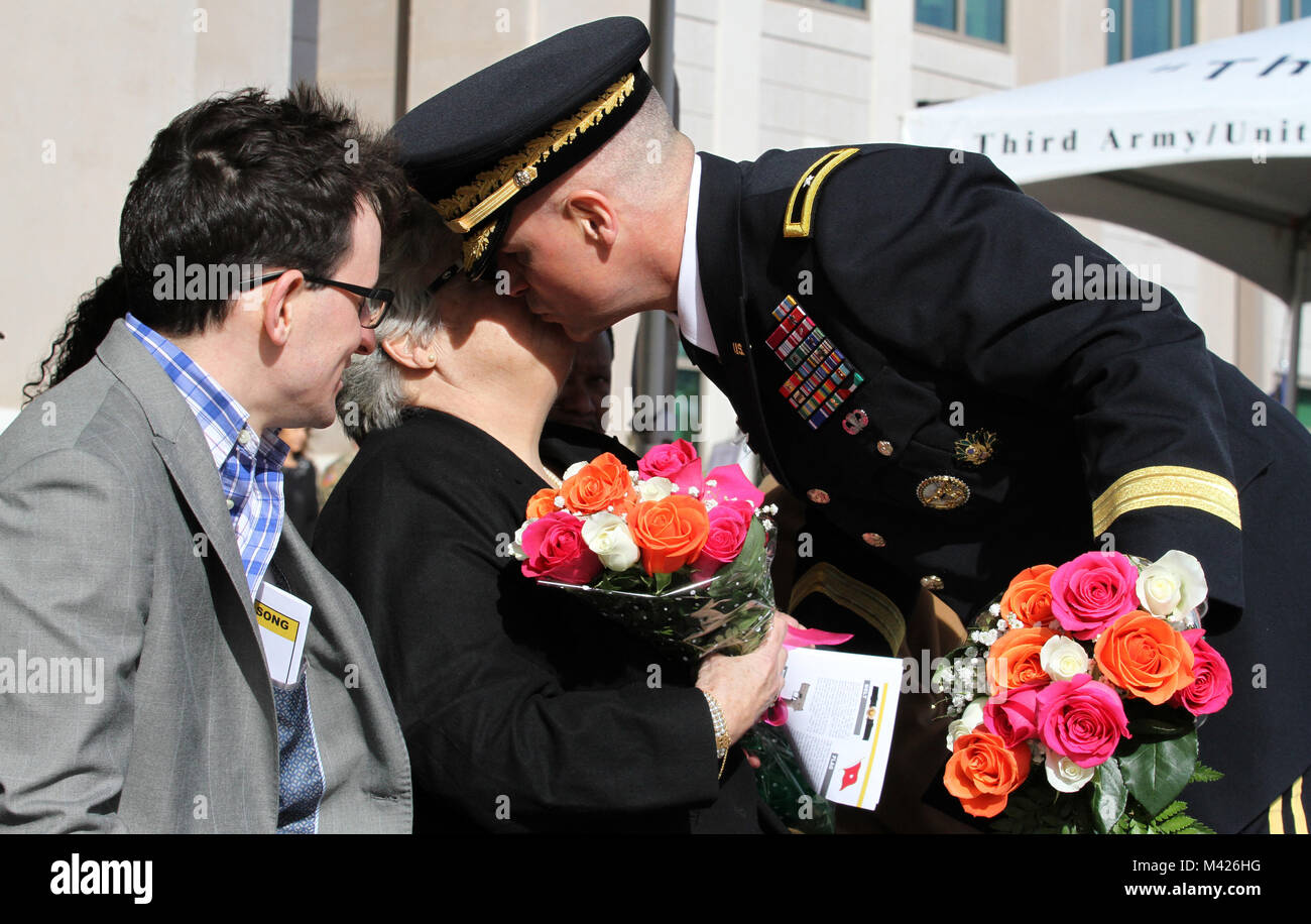 SHAW AIR FORCE BASE, S.C. (Feb. 2, 2018) - Brig. Gen. Michael T. Morrissey, the U.S. Army Central director of operations, gives his mother a kiss on the cheek as he presents her with a bouquet of roses during his promotion ceremony here. Morrissey is part of the less than 1 percent of his commissioning year group to attain general officer rank. (U.S. Army photo by Staff Sgt. Christal M. Crawford/Released) Stock Photo