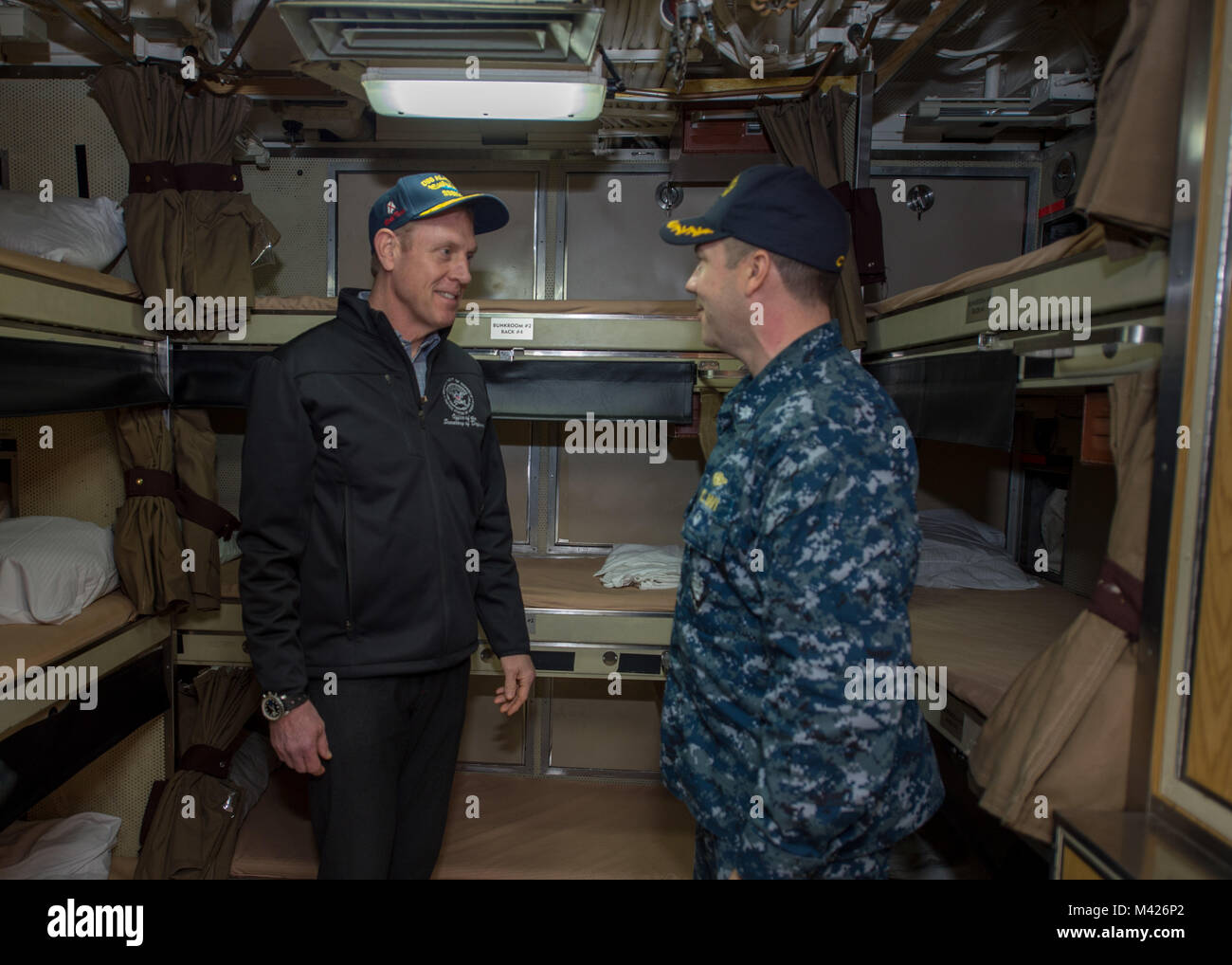 BANGOR, Wash. (Feb. 9, 2018) Cmdr. Jeffery Yackeren commanding officer to Ohio-class ballistic missile submarine USS Alabama (SSBN 731), shows  Deputy Secretary of Defense Patrick Shanahan sailors living quarters. Alabama is one of eight ballistic-missile submarines stationed at the base, providing the most survivable leg of the strategic deterrence triad for the United States.   (U.S. Navy photo by Mass Communication Specialist 2nd Class Nancy C. diBenedetto/Released) Stock Photo