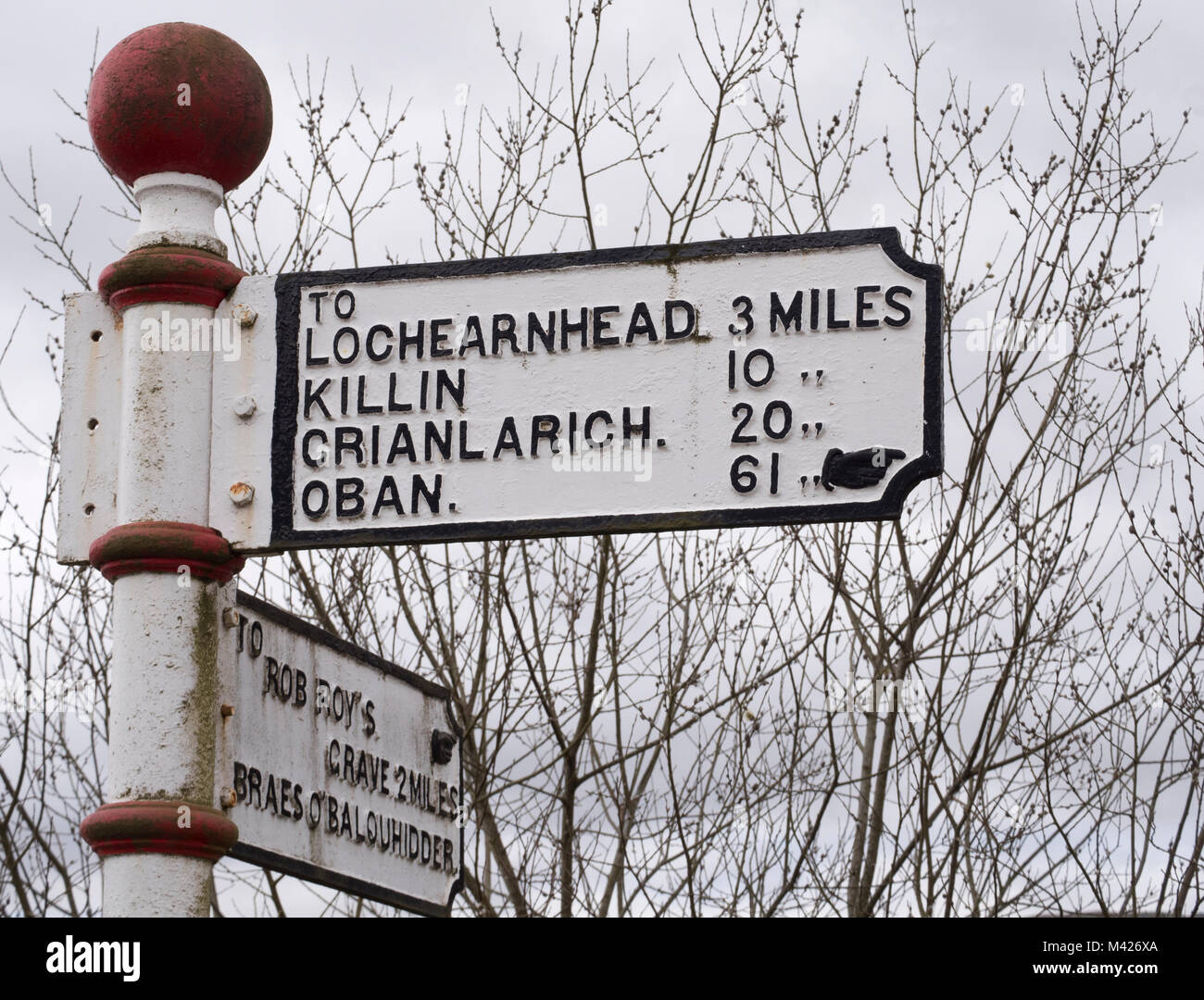 Fingerpost sign directing travellers towards Rob Roy's Grave or towards Lochearnhead, Balquhidder, Perthshire, Scotland, UK. Stock Photo