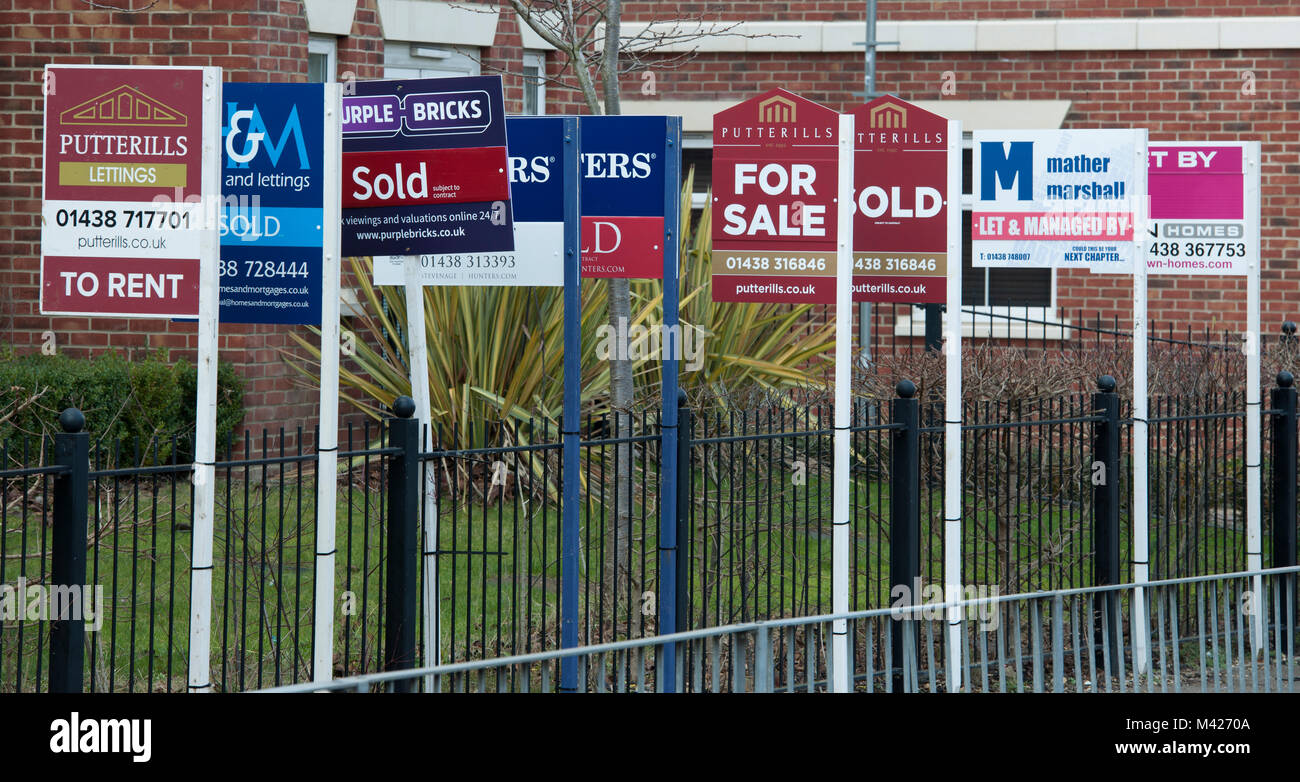 A row of estate agents sale boards outside flats in Stevenage, Hertfordshire, England, UK. Stock Photo