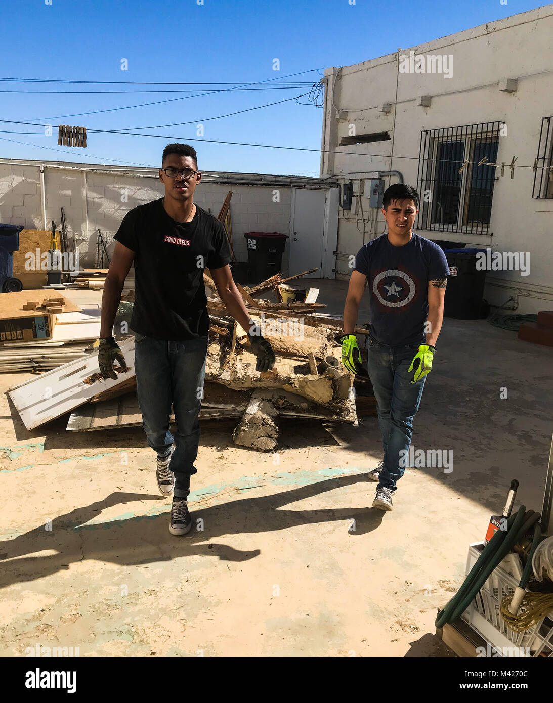 U.S. Marine Corps Cpl. Isaac D. Martinez and Lance Cpl. Joel Soriano, both strategic communication specialists with to Marine Corps Air Station (MCAS) Yuma’s Headquarters & Headquarters Squadron, volunteer their Saturday to tear down a shed at St. Thomas Yuma Indian Mission in Winterhaven, Calif., Feb. 3, 2018. The mission, located out in the local Yuma community, requested help in tearing down the shed so that renovations could be made to the building. (U.S. Marine Corps photo taken by Cpl. Isaac Martinez) Stock Photo