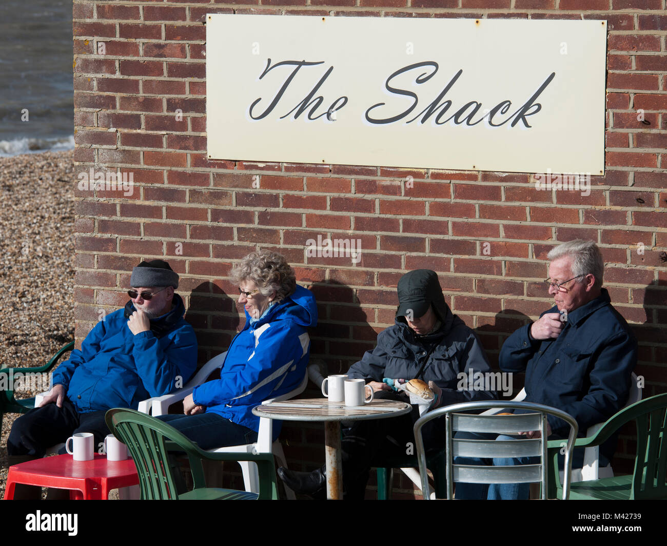 Two elderly couples enjoying a cuppa during a winter outing at Lee-on-the-Solent, Gosport, Hampshire, England, UK Stock Photo