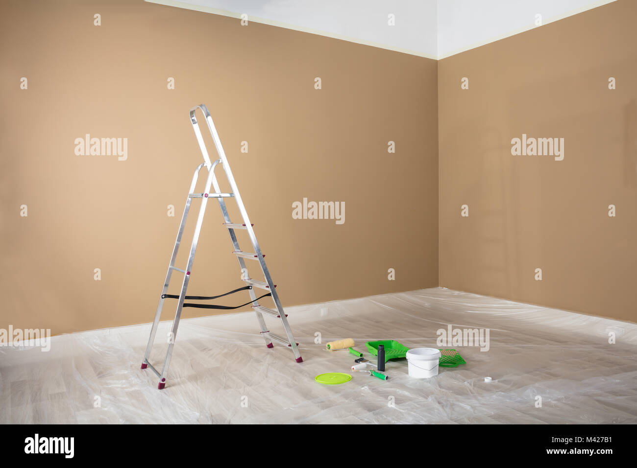 Freshly Painted Room With Ladder And Painting Equipments At Home Stock
