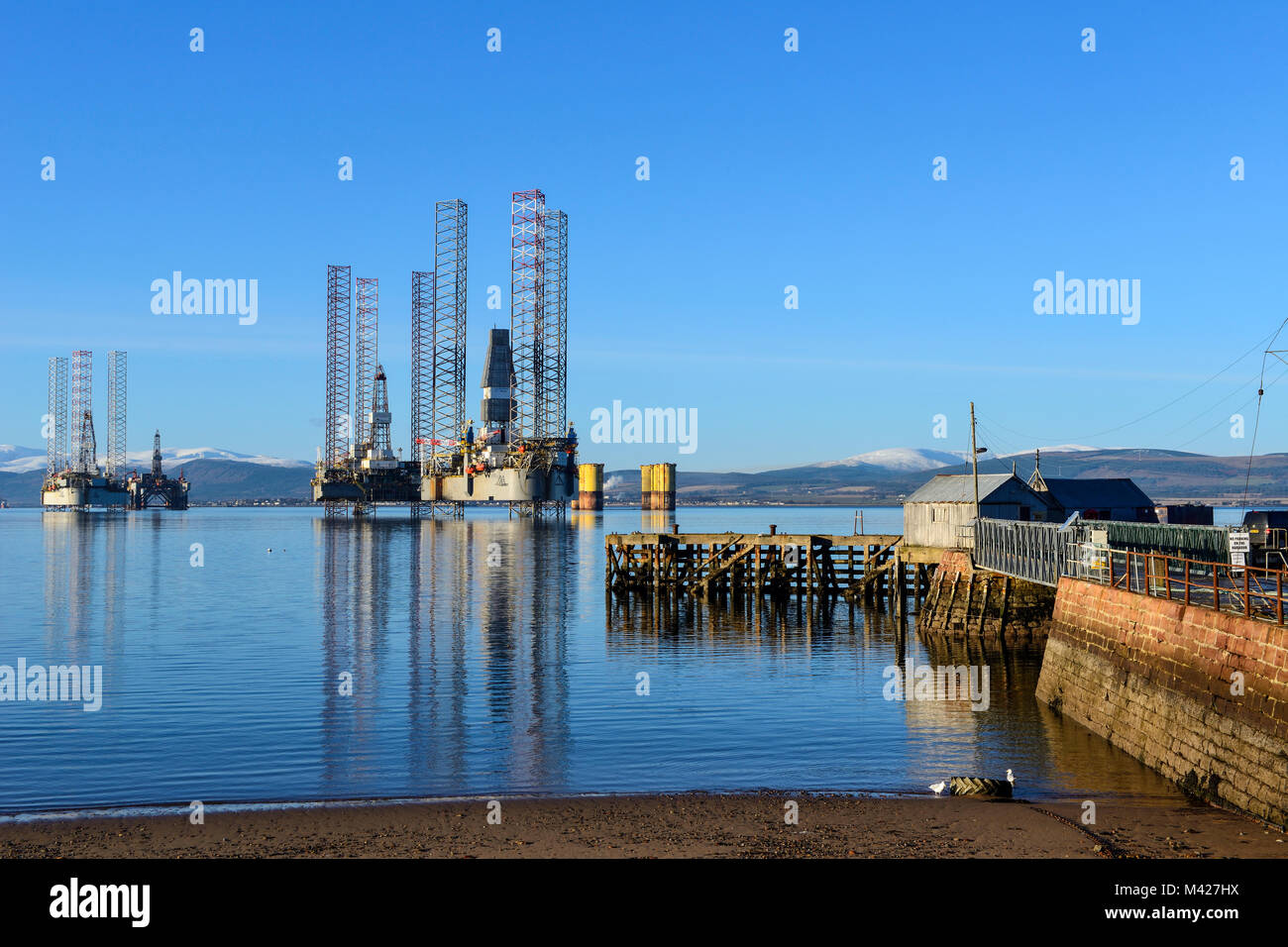 Oil rigs / drilling platforms moored in Cromarty Firth viewed from town of Cromarty on the Black Isle in Ross & Cromarty, Highland Region, Scotland Stock Photo