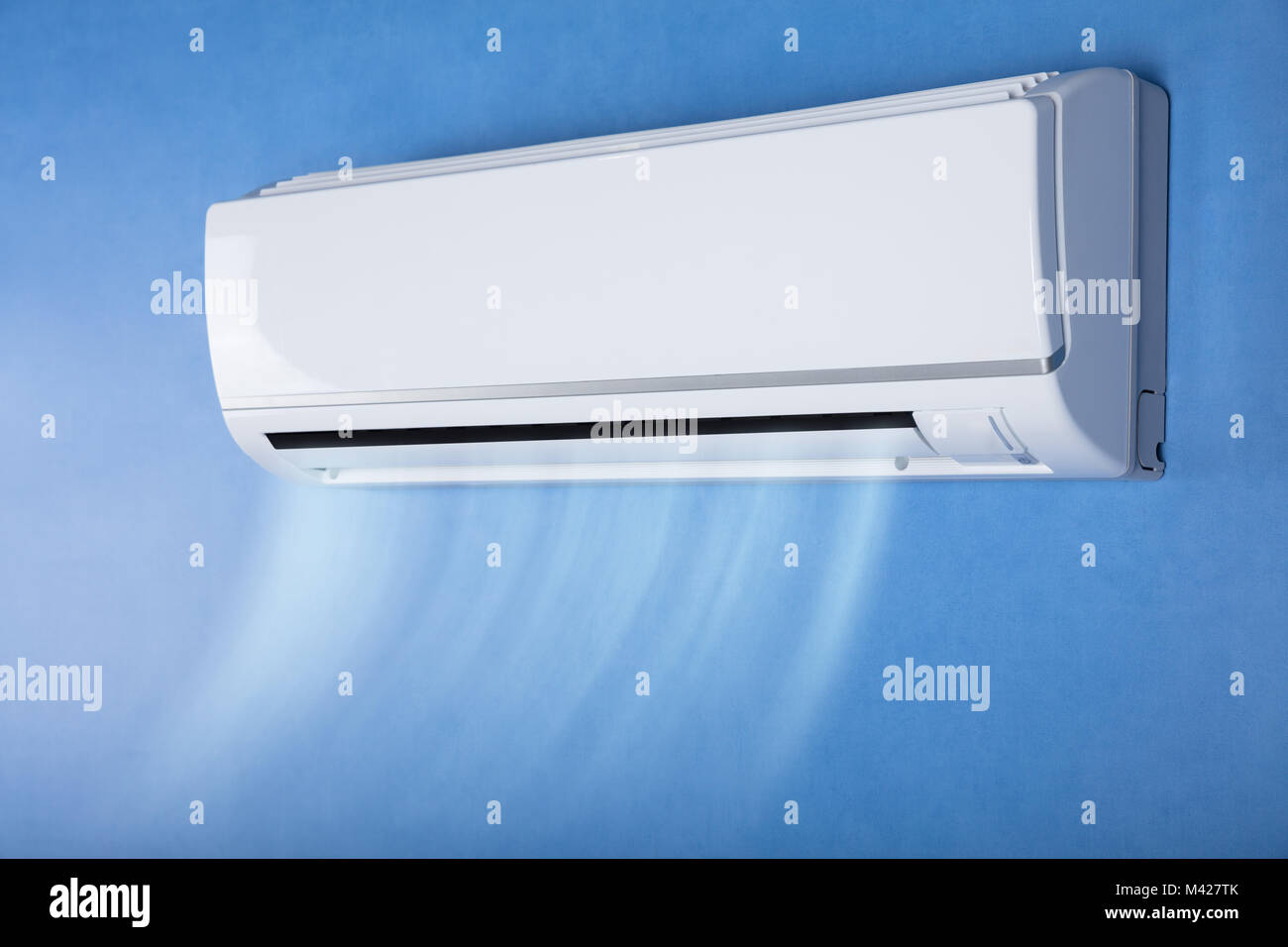 White Air Conditioner On Wall In Living Room Stock Photo - Alamy