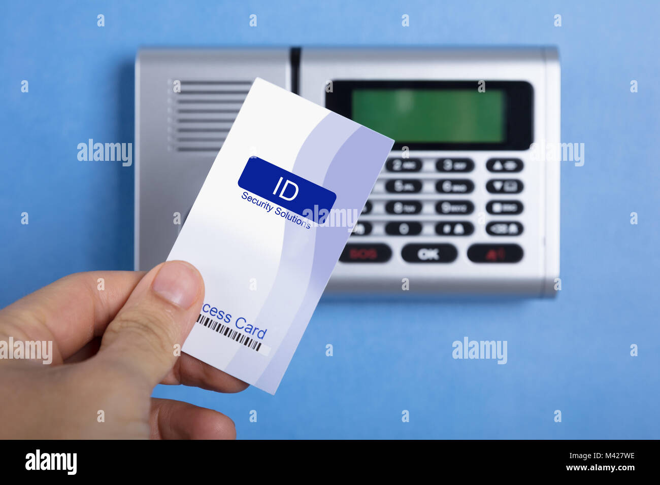 A Person's Hand Holding Access Card To Lock And Unlock Door Stock Photo