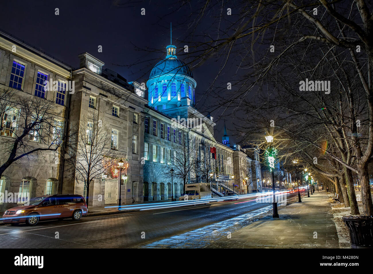Facade of the Bonsecures Market building. The Palladian-style dome is lighted in blue. View is along the rue Saint-Paul Est at night. Stock Photo