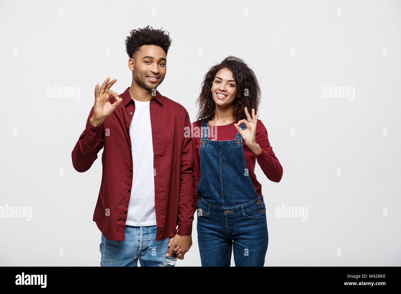Portrait of a cheerful young african couple standing together and ...