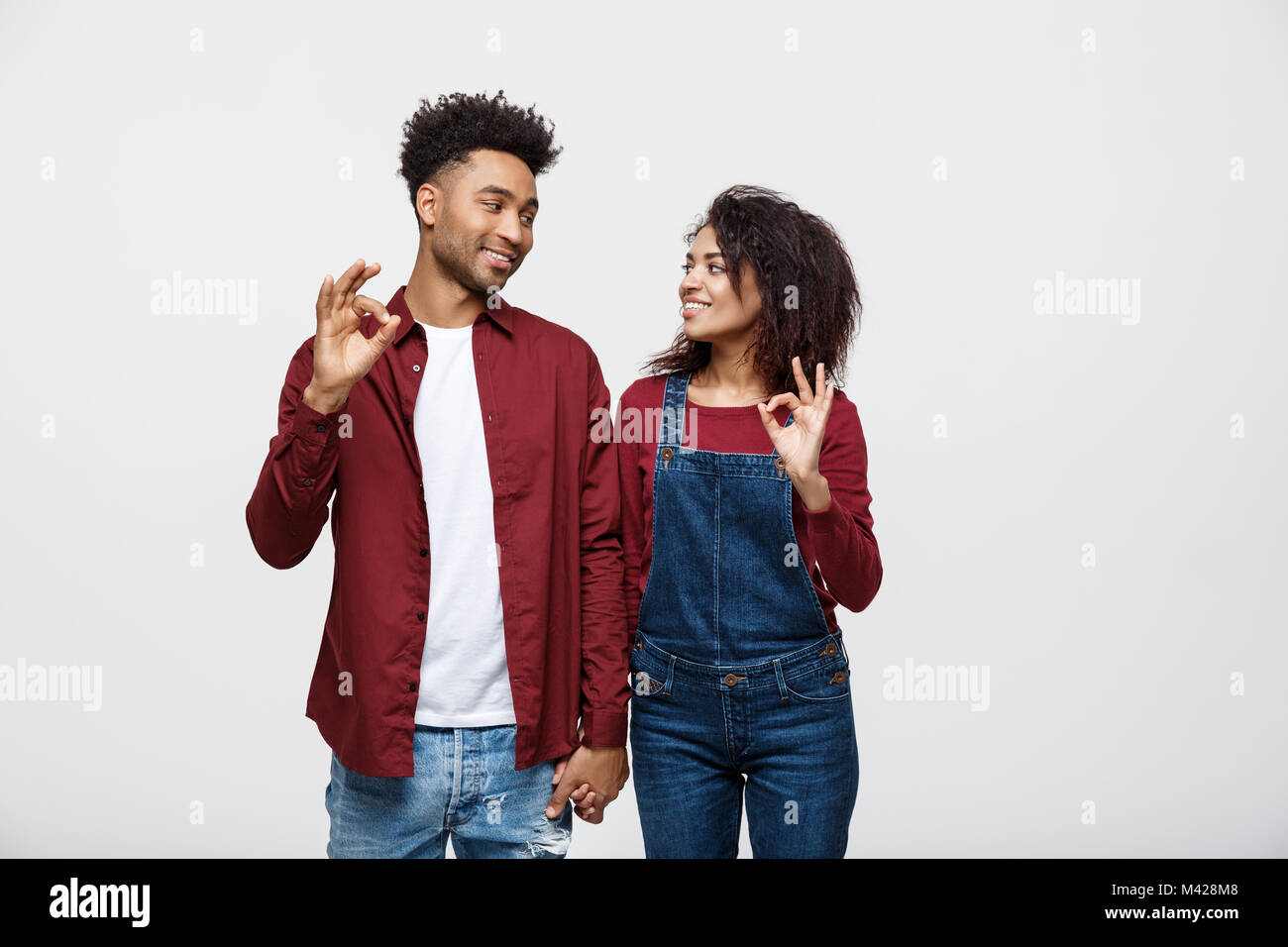 Portrait of a cheerful young african couple standing together and ...