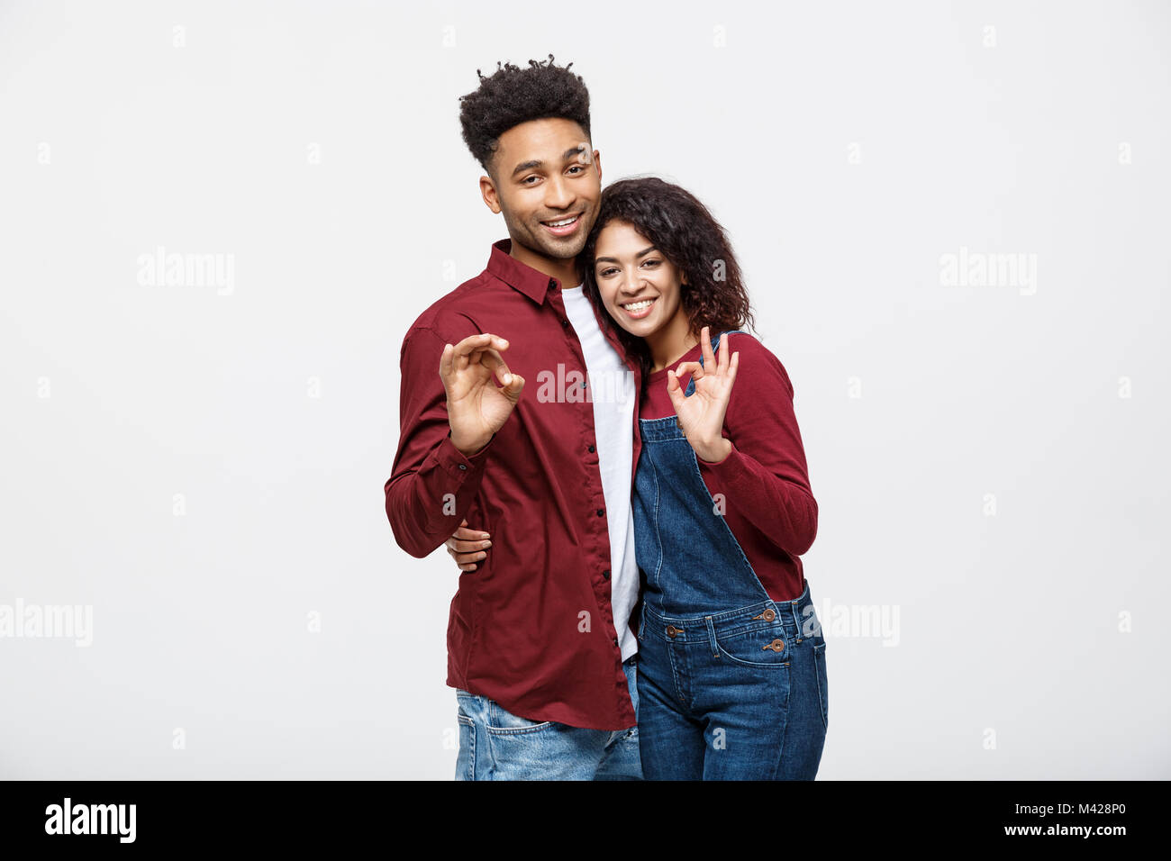 Portrait of a cheerful young african couple standing together and ...